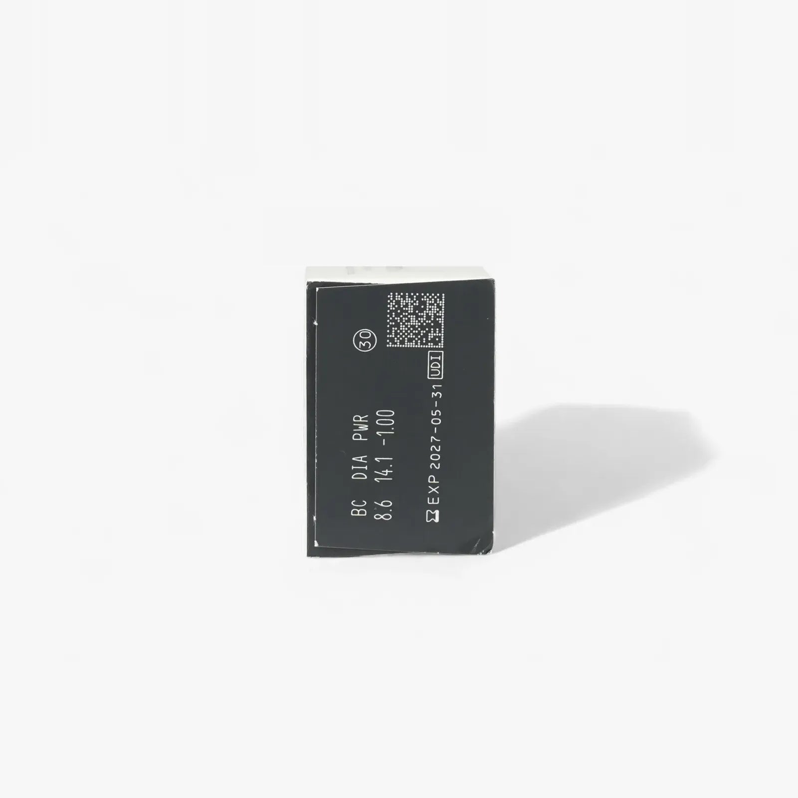 A rectangular black electronic component with white alphanumeric markings and a small QR code on top, shown against a plain white background—similar to the packaging of Clariti 1Day Sphere 30-Pk lenses for online contact lens buyers.