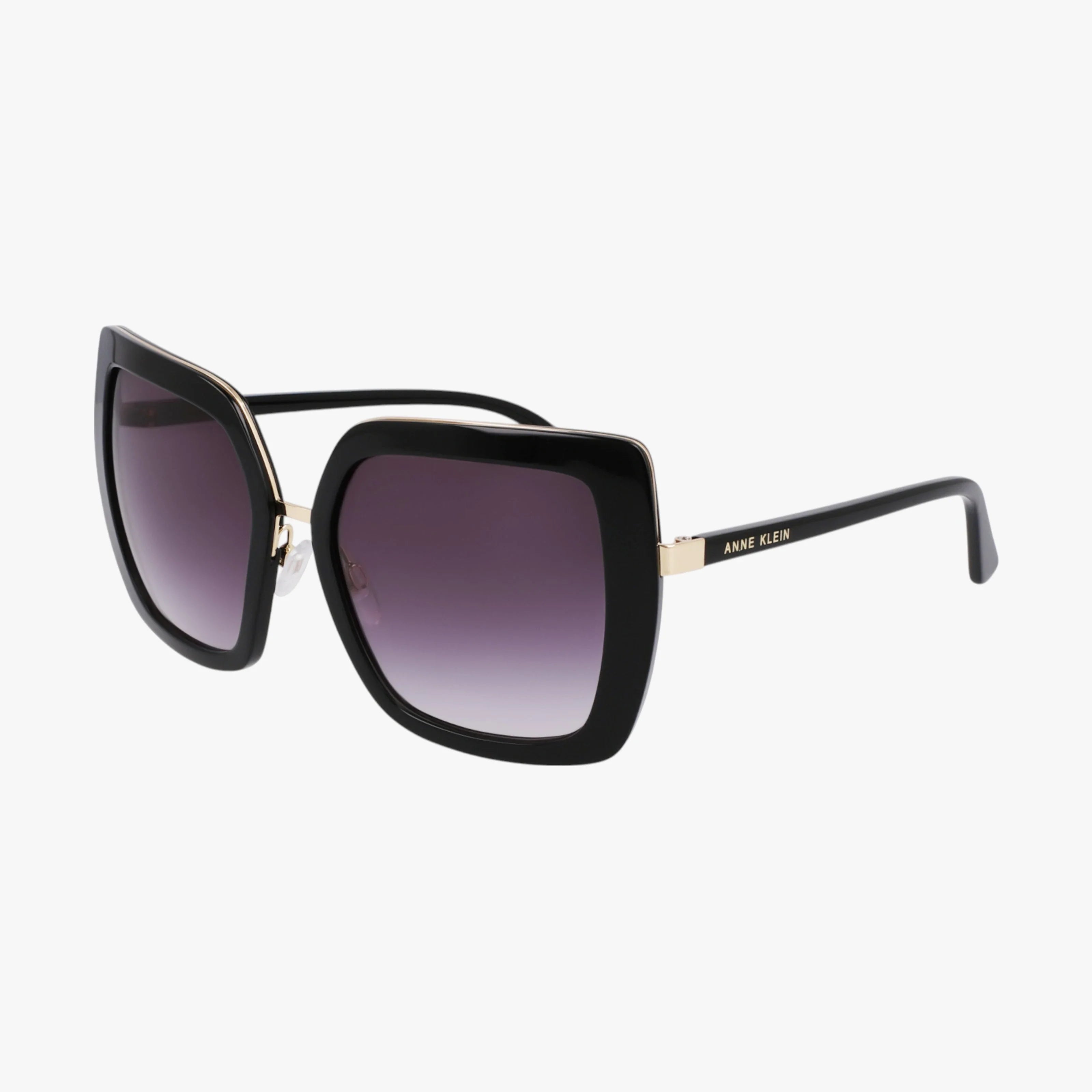 The AK7095 sunglasses feature oversized square black frames, dark gradient lenses, and gold accents on the arms with the Anne Klein logo—a stylish and durable choice for those shopping online for trendy eyewear.