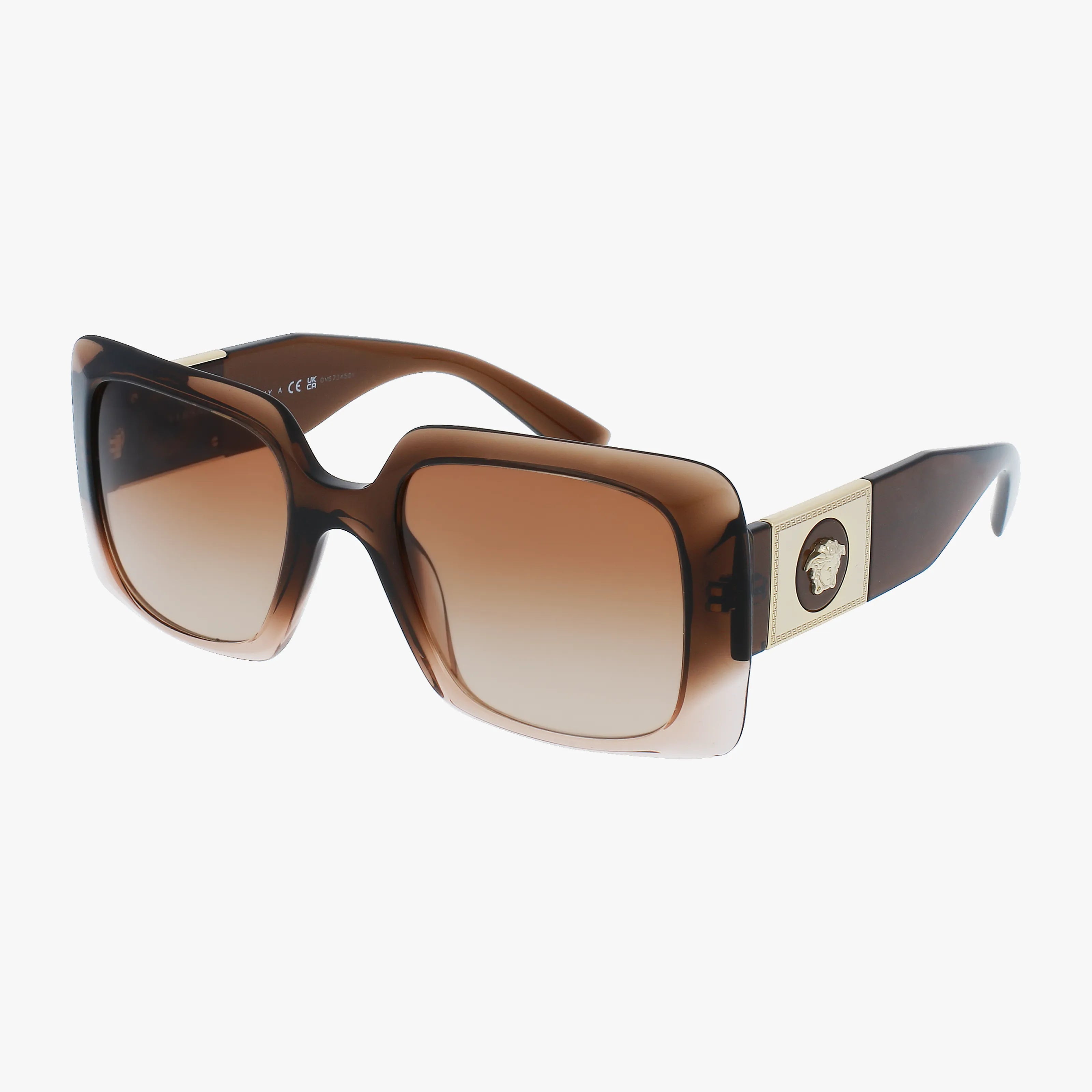 The VE4405 sunglasses feature an oversized brown square frame with gradient lenses and gold Versace Medusa emblems on wide temples, offering chic sun protection. Displayed on a white background, these sunglasses exude luxury style.