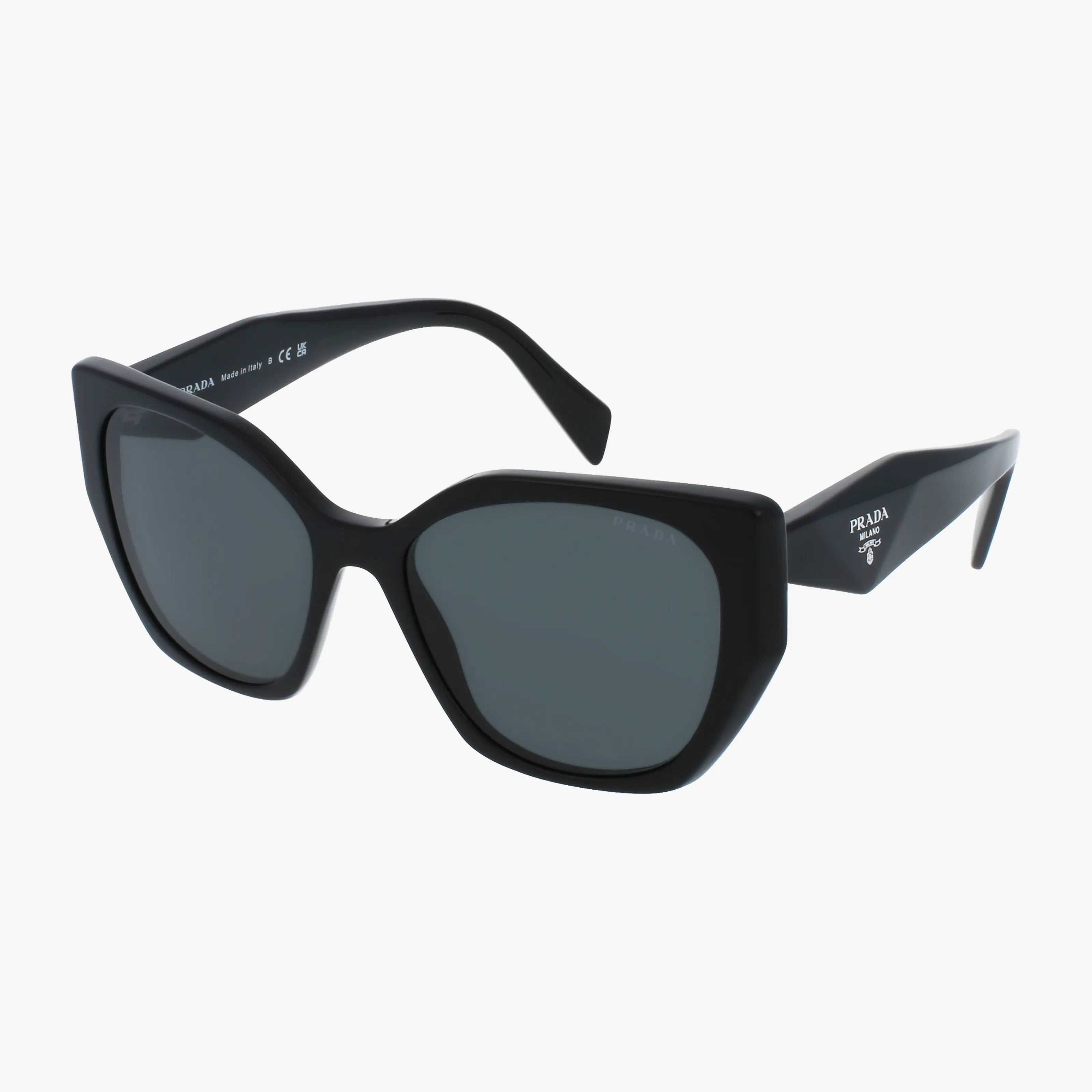 The PR19ZS sunglasses by Prada feature large, angular black frames with dark lenses and the Prada logo in white on thick, wide temple arms, shown against a plain white background.