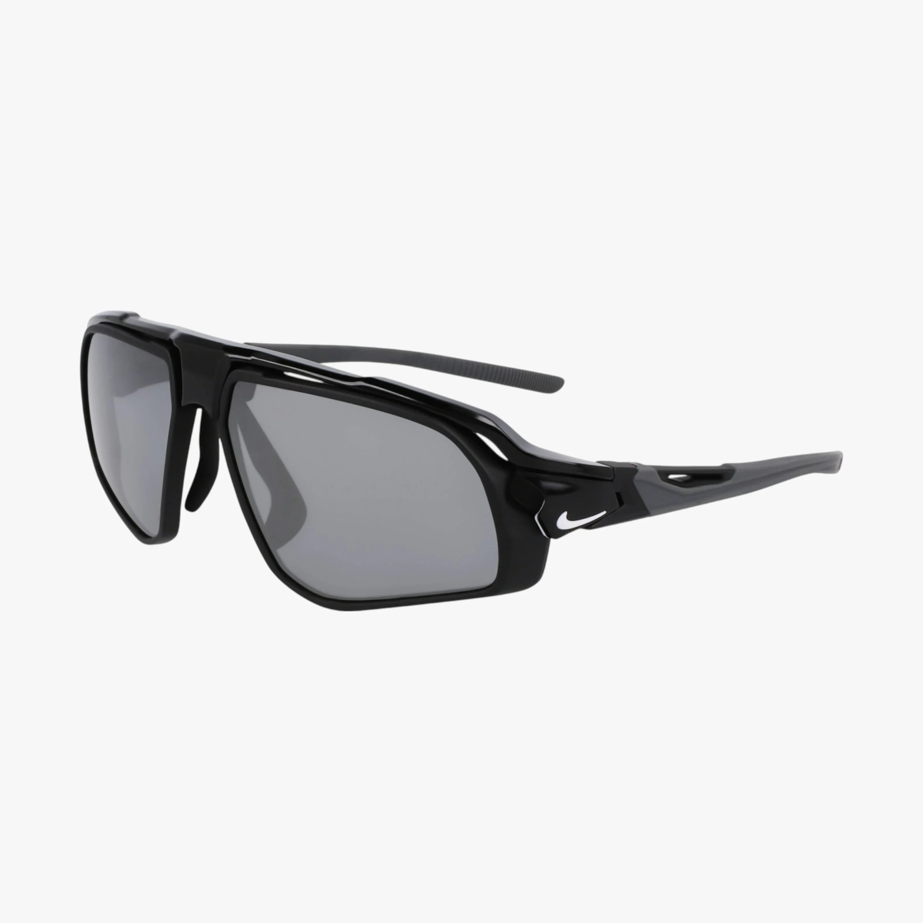 The NIKE FV2387 sunglasses feature black angular frames, gray UV-protective lenses, a white Nike logo on the temples, and a modern ventilated design for a sporty look.