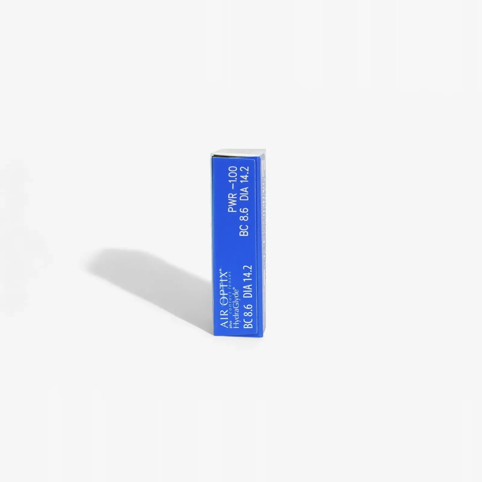 An upright rectangular blue and white Air Optix Plus Hydraglyde - 6Pk box is shown on a white background with a left-cast shadow. The box includes monthly lens specs such as power, base curve, and diameter.