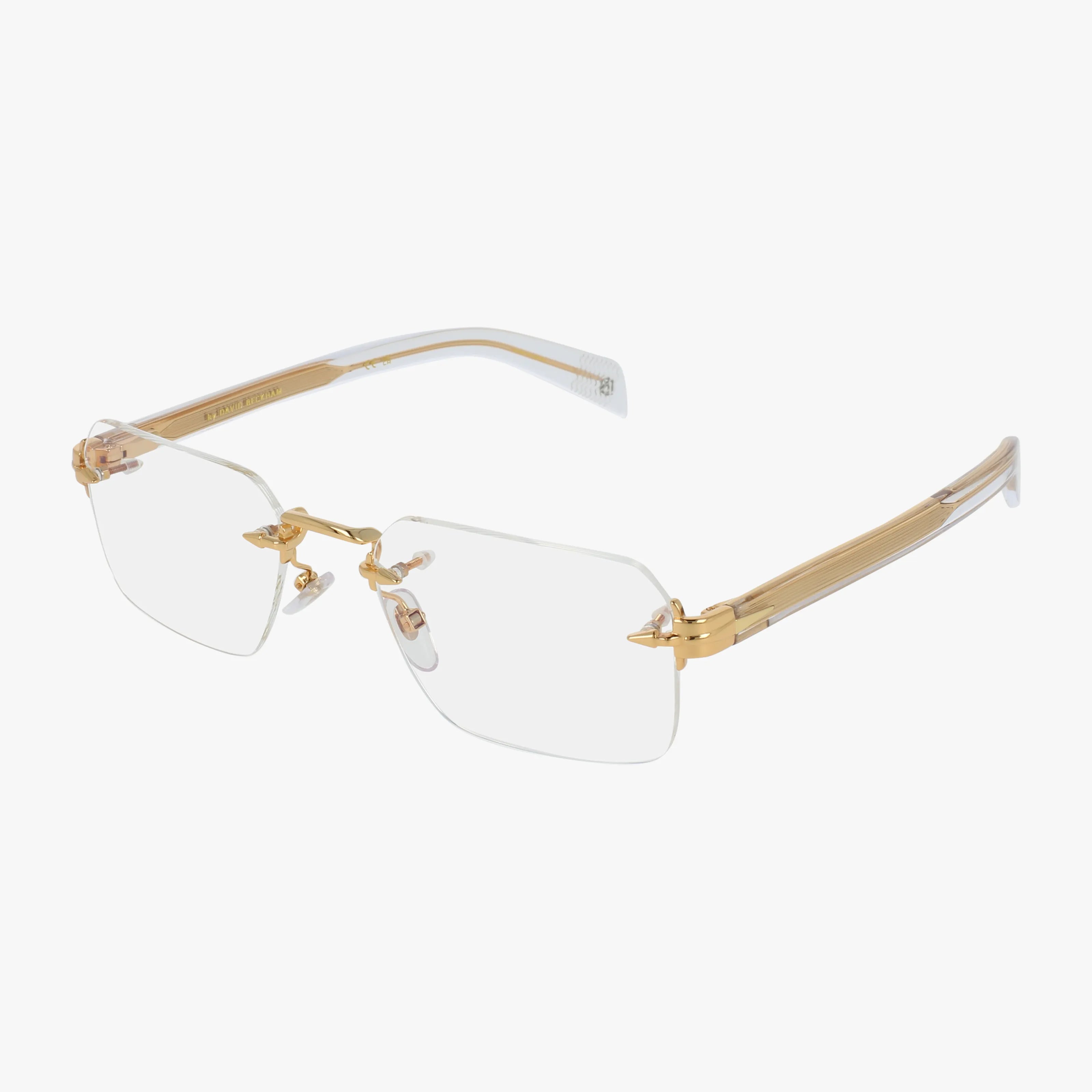 The DB 7116 features rimless rectangular lenses, gold metal temples, and clear nose pads for quality craftsmanship and a lightweight frame, shown on a white background.
