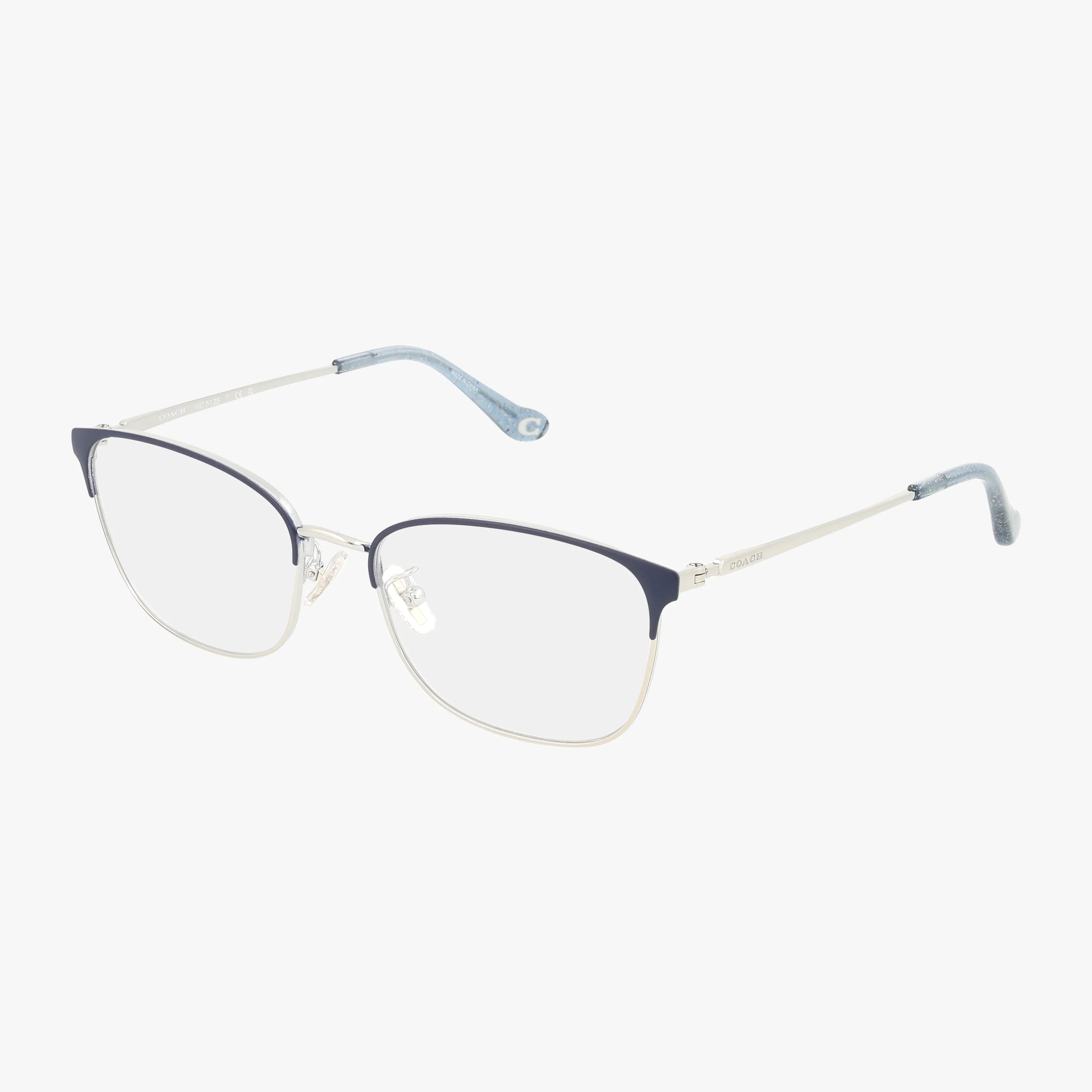 The HC5135 eyeglasses feature thin silver metal frames with blue accents on the upper rims and temple tips, showcasing a contemporary design ideal for daily wear, and are displayed on a plain white background.