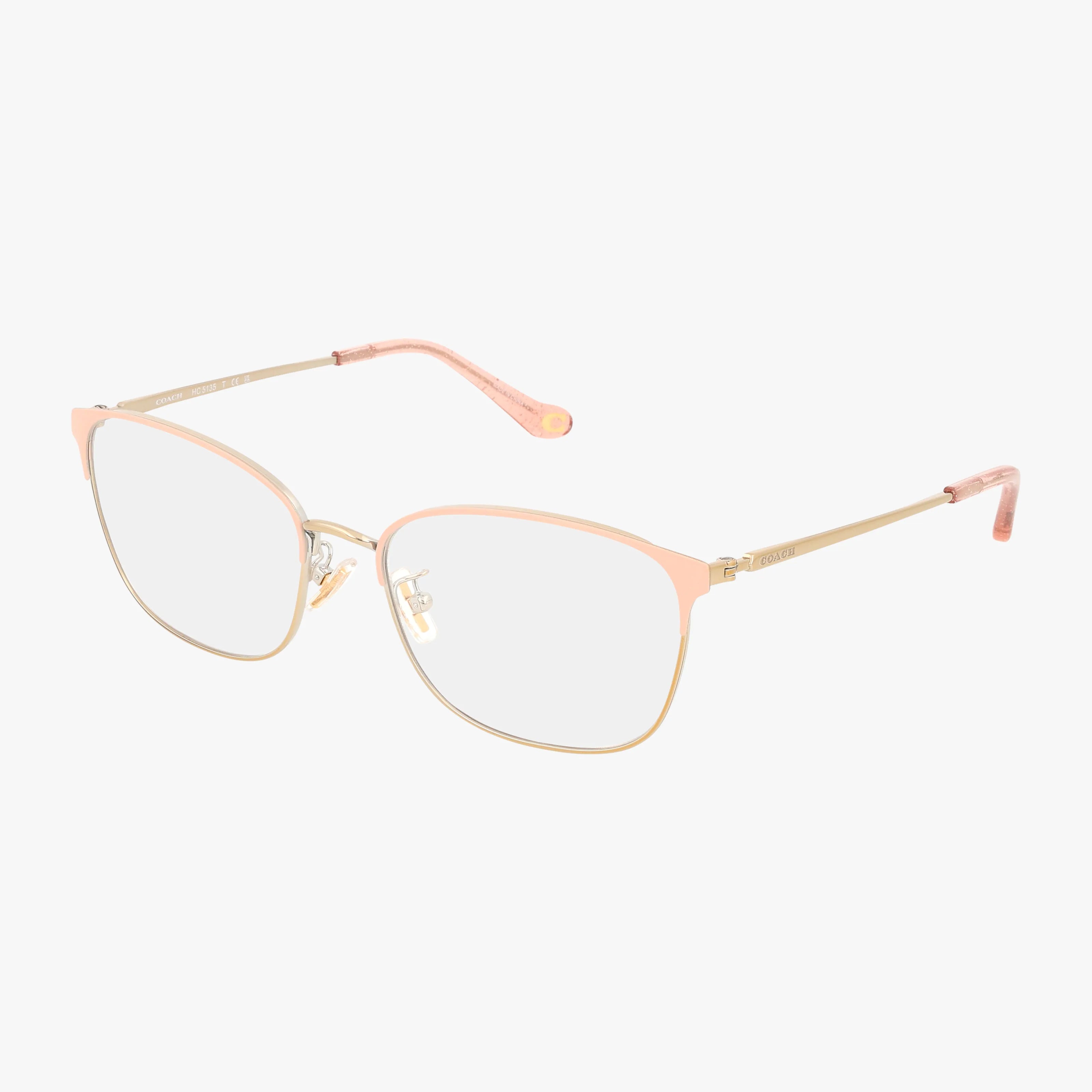 The HC5135 eyeglasses feature a lightweight frame with thin gold metal and light pink accents on the rims and temple tips—perfect for everyday wear, shown against a white background.