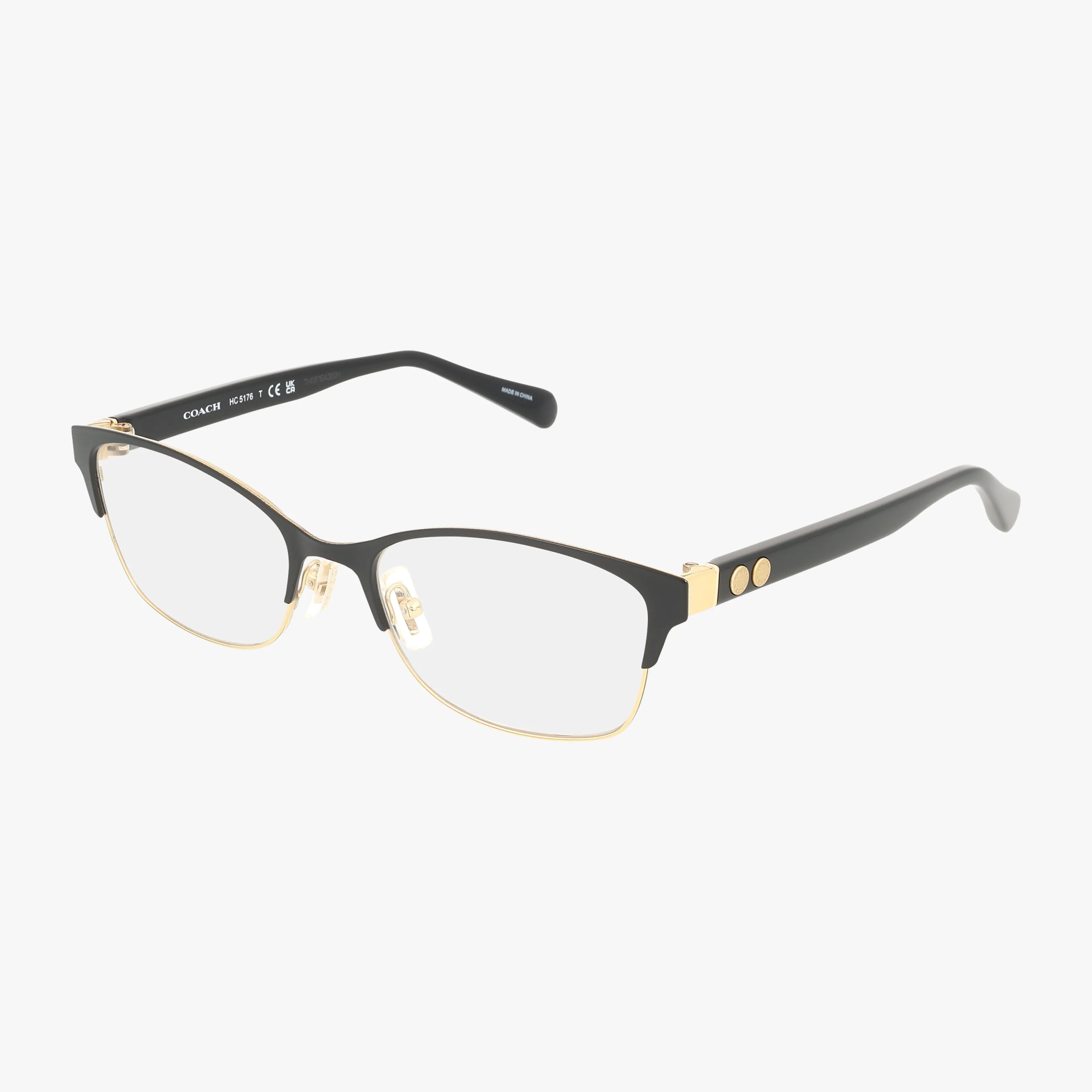 The HC5176 eyeglasses feature a slim black and gold rectangular frame with clear lenses, metal accents, and two round gold details on the temples. Adjustable nose pads ensure comfort and durability for everyday wear.