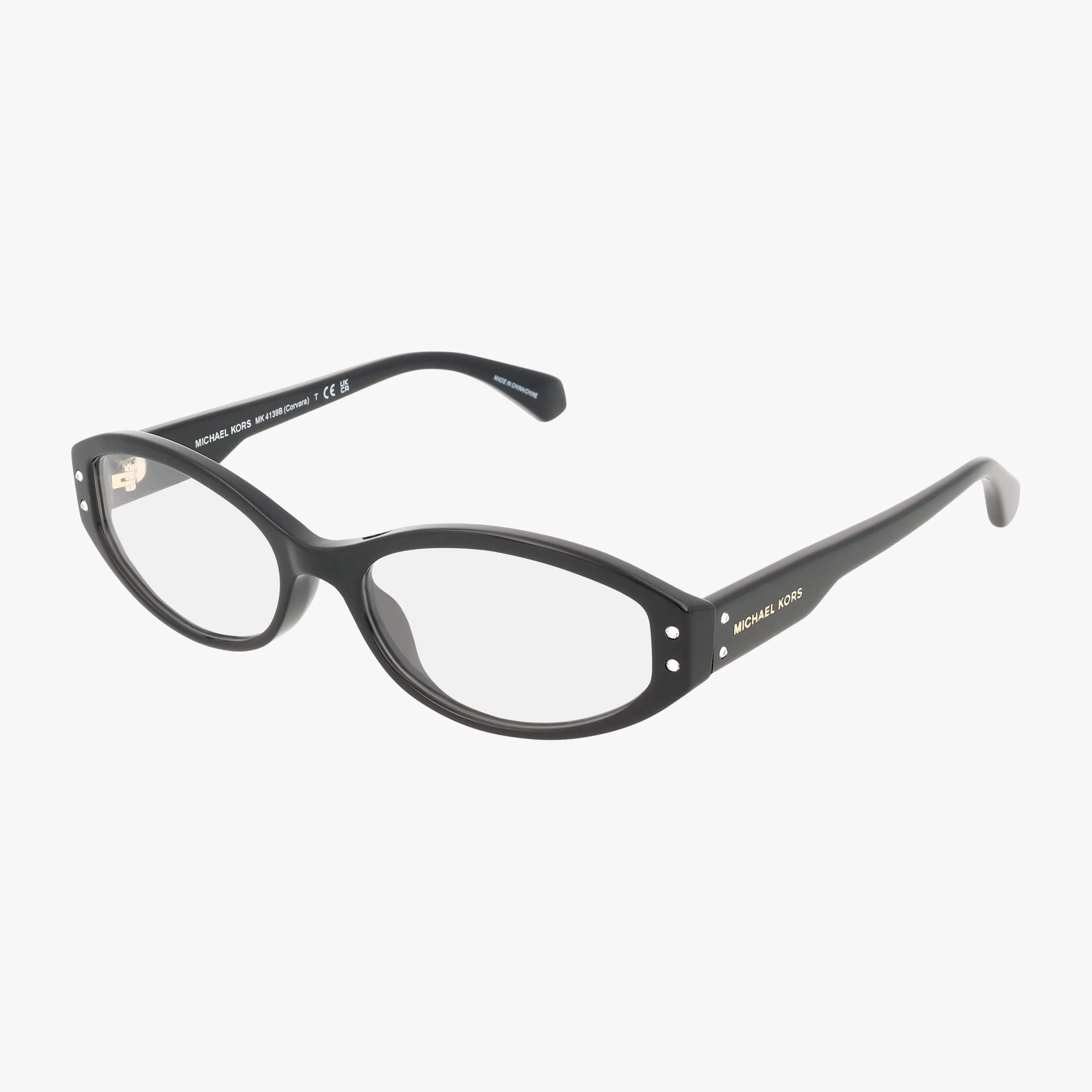 The MK4139B is a pair of black oval eyeglasses with clear lenses, silver accents on the front corners, and Michael Kors branding on the temples, designed for lightweight comfort and shown on a white background.