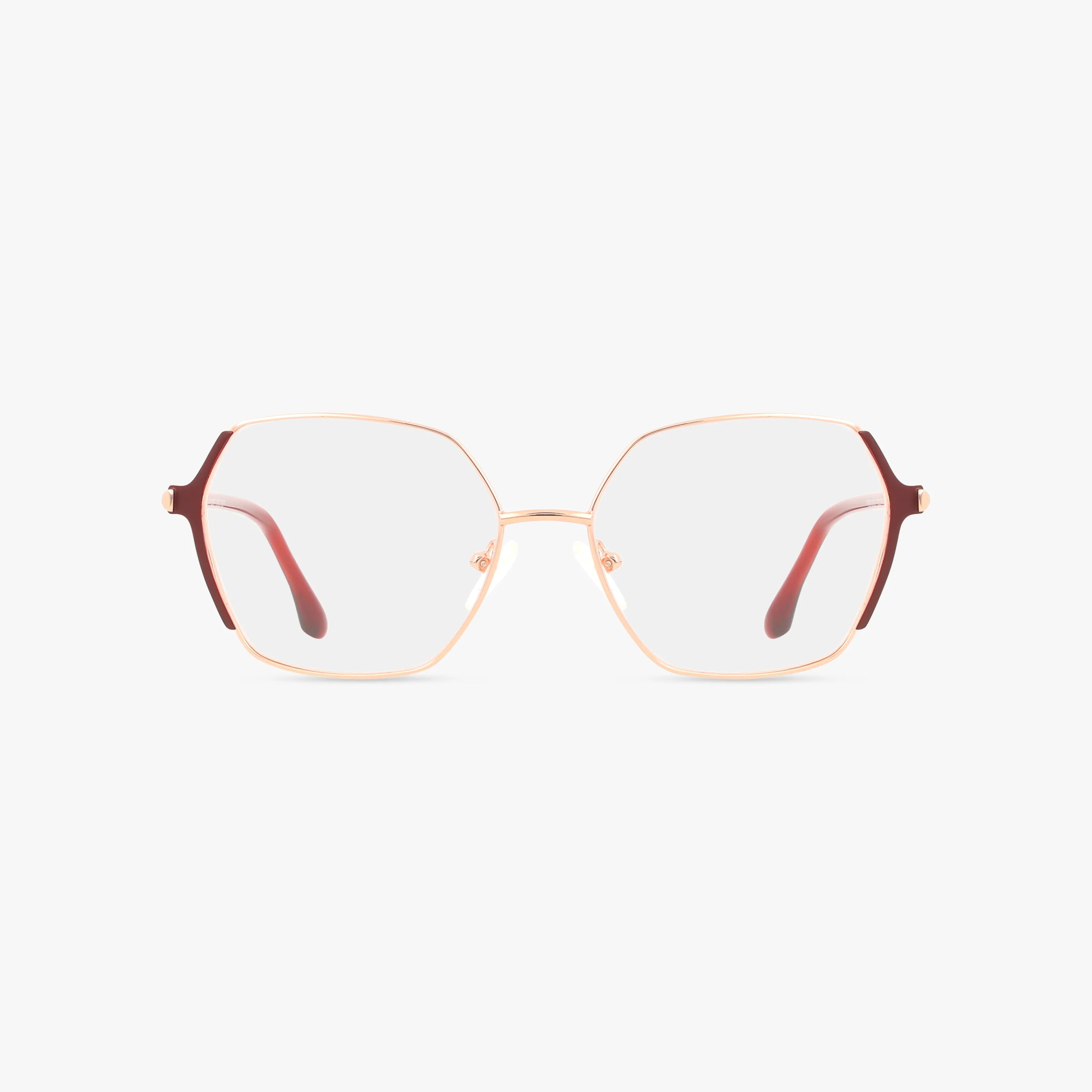 KARINA gold-rimmed eyeglasses feature oversized hexagonal frames, red temple tips, and a minimalist design for modern durability, shown on a white background.