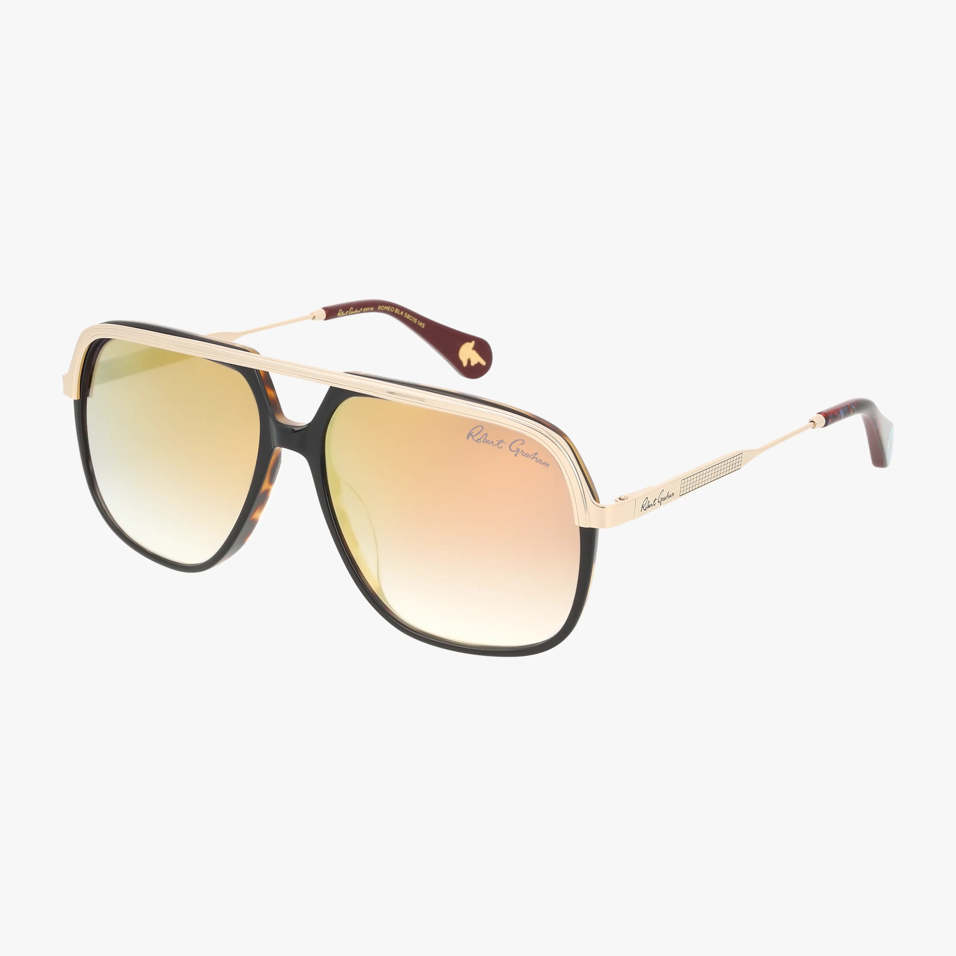 ROMEO gold and black aviator sunglasses feature a durable frame, gradient yellow-to-pink lenses, a double bridge, thin arms with Robert Graham branding on the temples—all set against a white background.