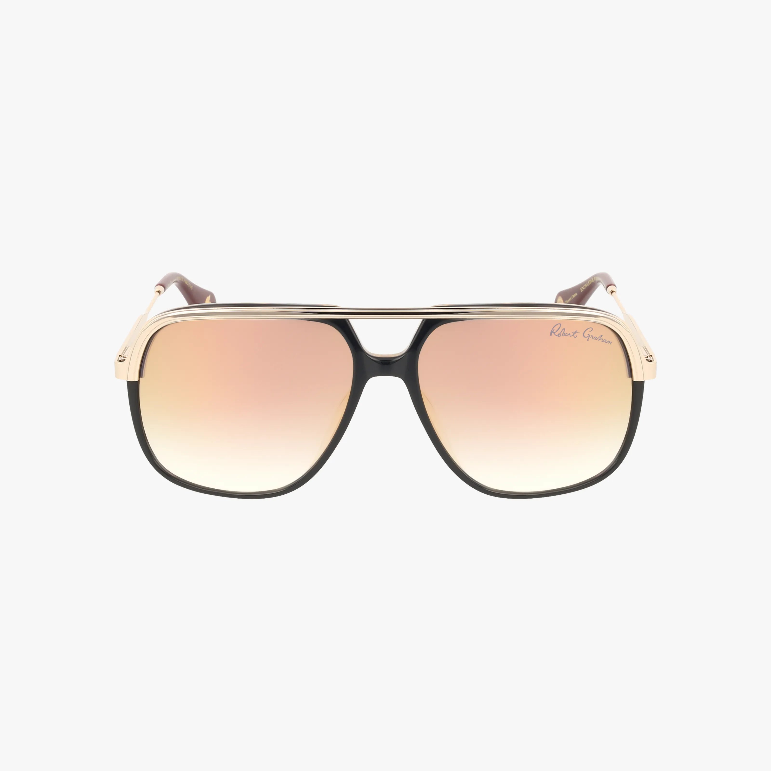 Front view of ROMEO aviator sunglasses with a durable black and gold frame, gradient brown lenses, a slim gold top bar, and subtle branding on the right lens.