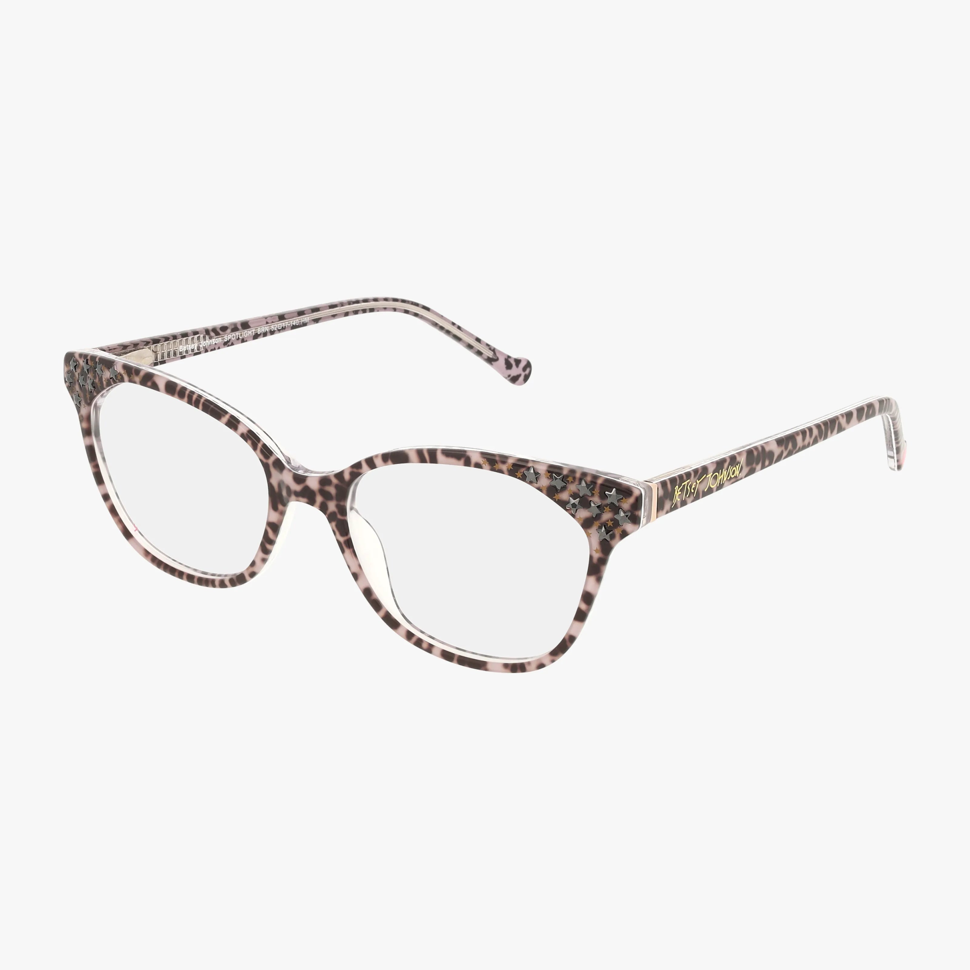 The SPOTLIGHT cat-eye spectacles feature bold leopard print frames, clear lenses, and upward-angled corners, shown on a white background in signature Betsey Johnson style.