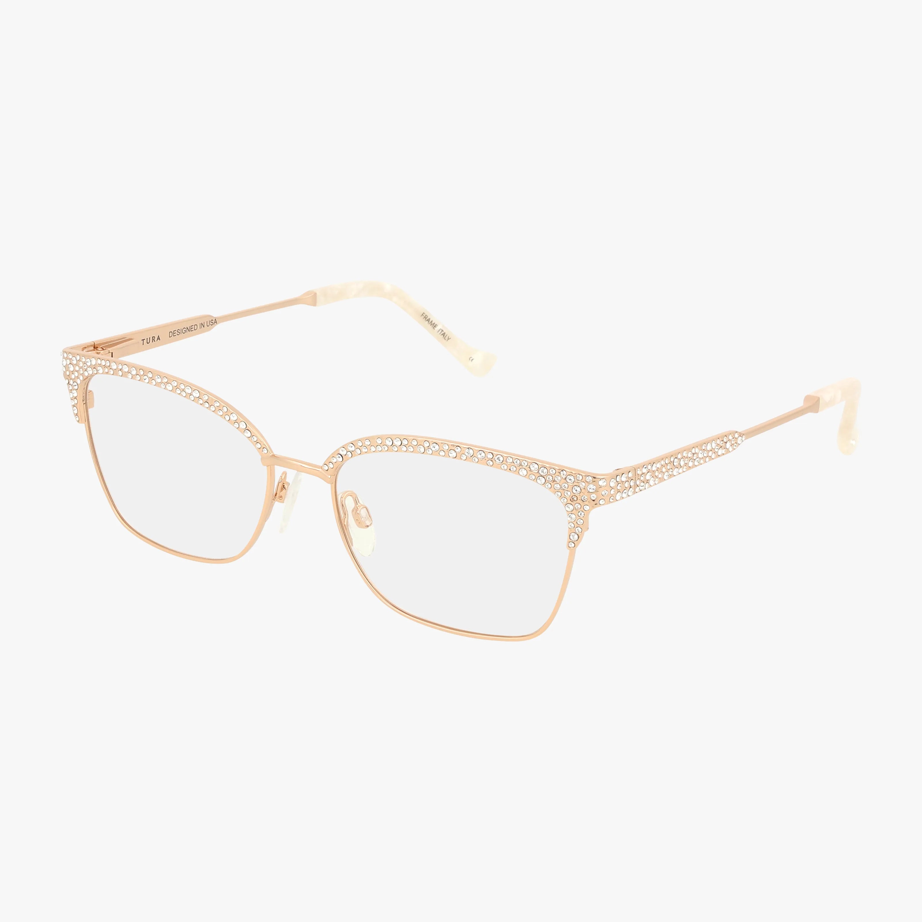 The TE274 eyeglasses feature gold-rimmed, lightweight frames with clear prescription lenses and crystal accents along the top. Marbled ivory temple tips add a touch of elegance. Shown against a white background.