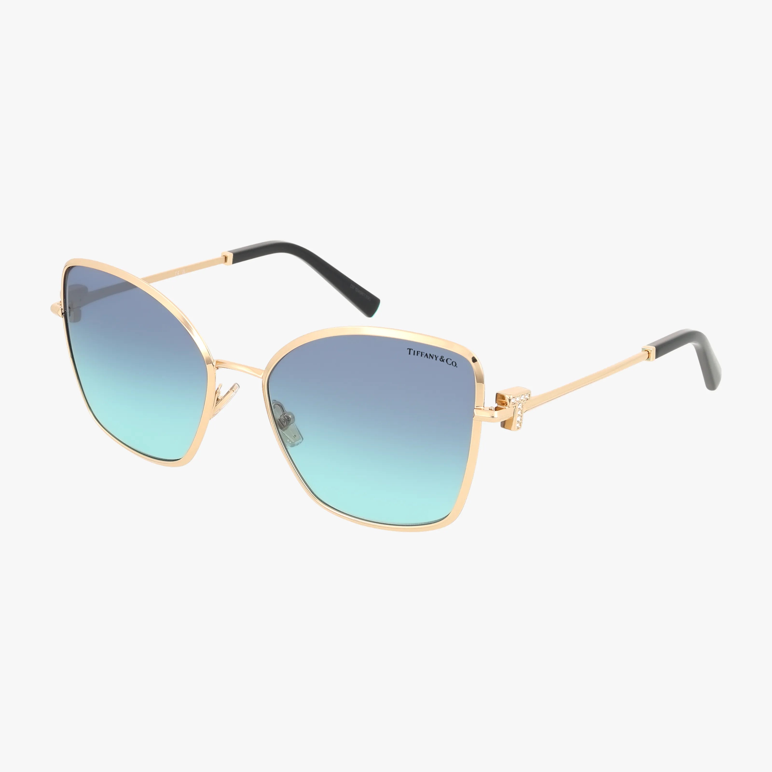 The TF3102B sunglasses feature gold rims, large square blue gradient lenses, and black temple tips. With a lightweight frame, theyre ideal for daily wear and are shown on a white background.