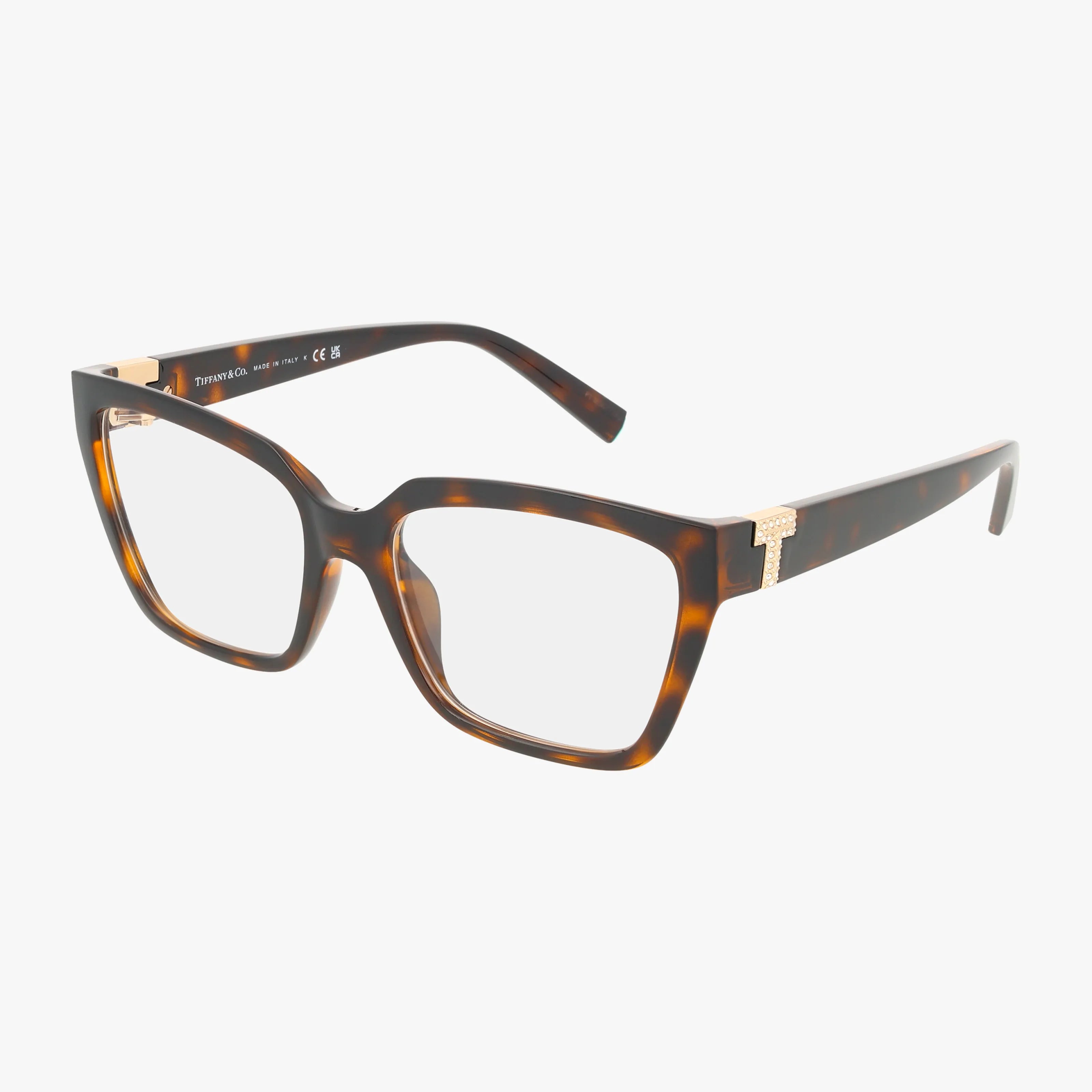 The TF2257BU features brown tortoiseshell rectangular frames with gold T accents on the temples, shown against a white background for a stylish look.