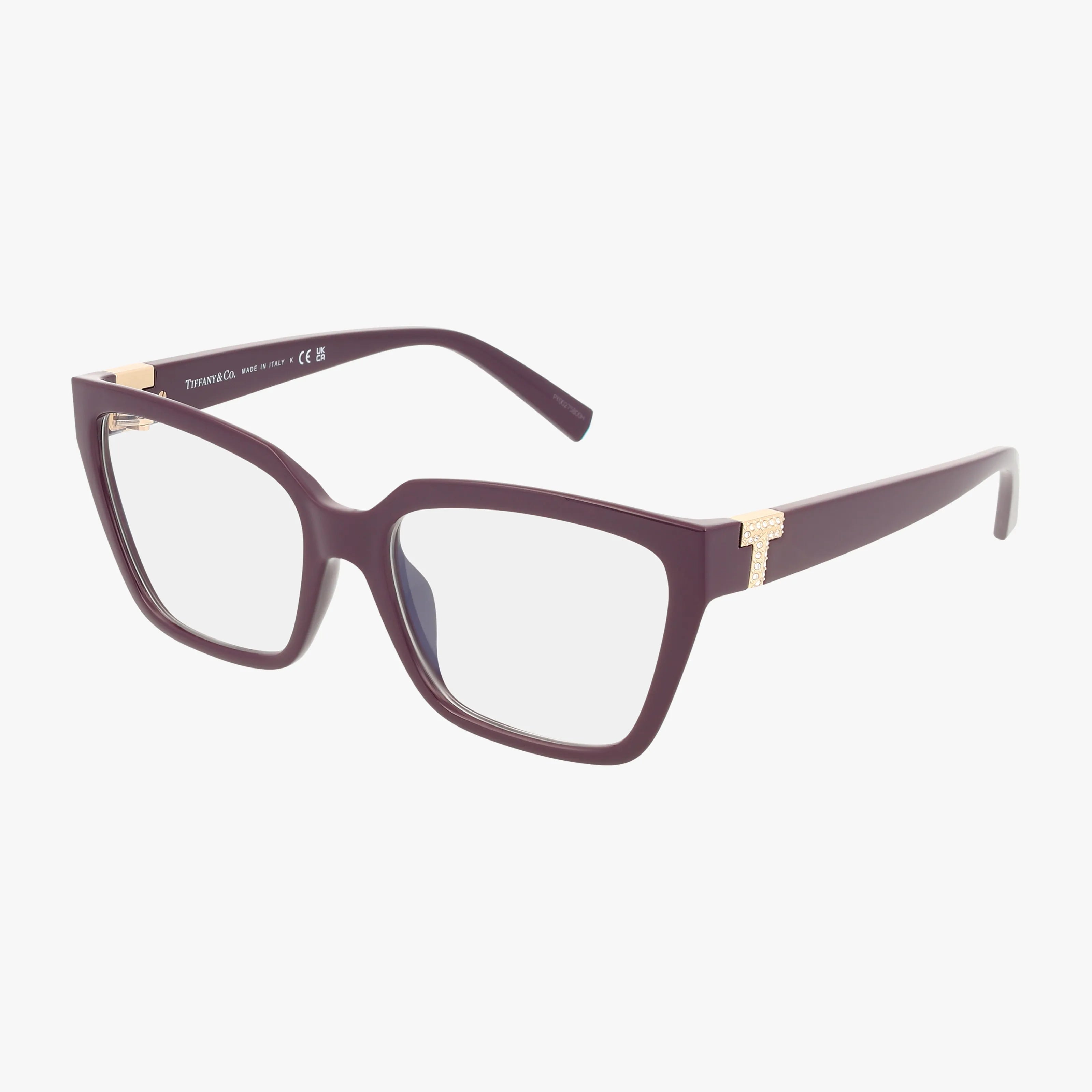 The TF2257BU eyeglasses feature a rectangular, dark purple frame with clear lenses, stylish gold temple accents, and a T-shaped hinge detail, all set against a plain white background.