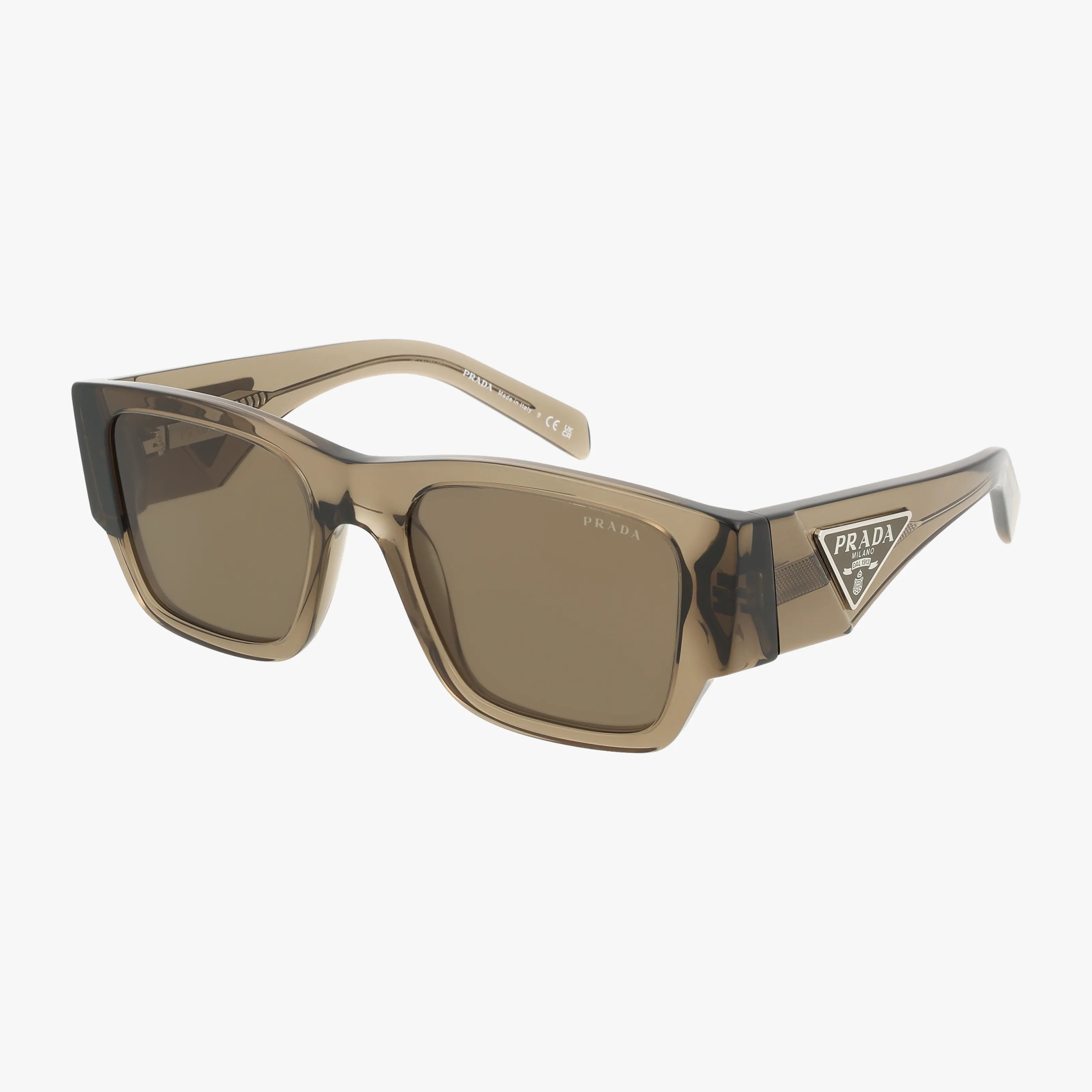 Prada PR10ZS sunglasses feature rectangular brown frames and dark tinted lenses. The thick temples are adorned with a silver Prada triangle logo, giving these bold sunglasses a modern edge.