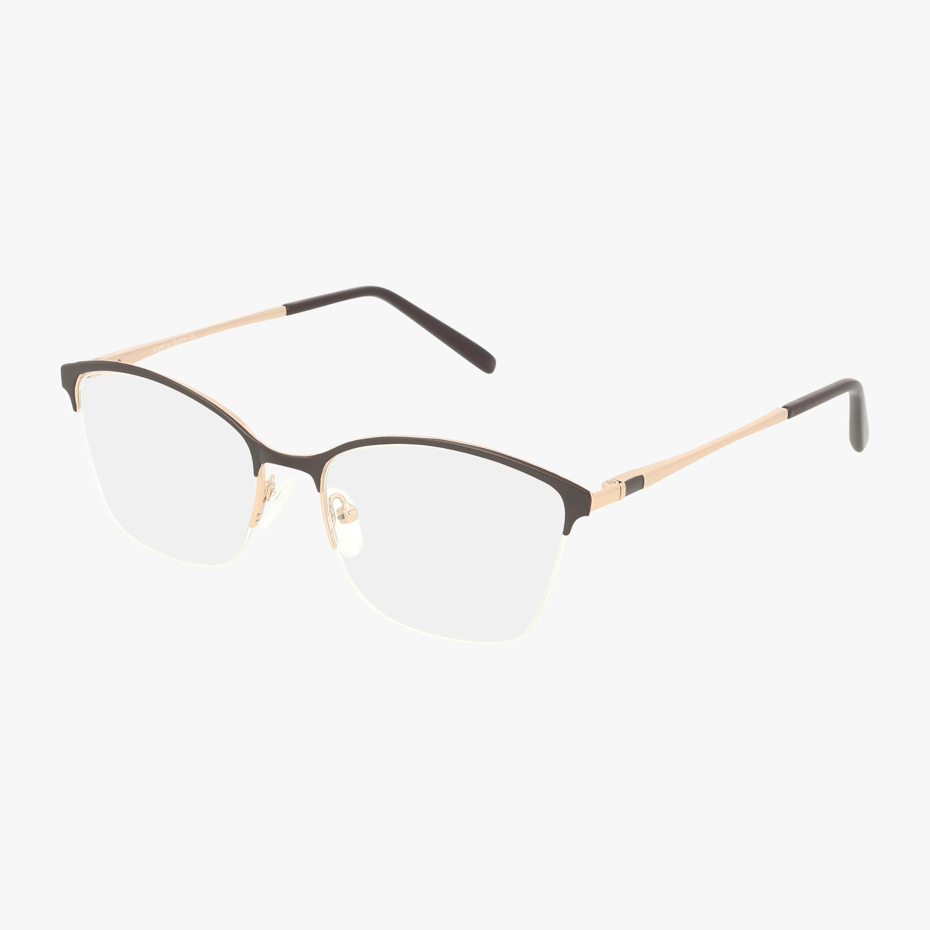 The ANNIE eyeglasses feature a semi-rimless design with a black upper frame, gold metal arms, and clear lenses, highlighting classic lines against a white background.