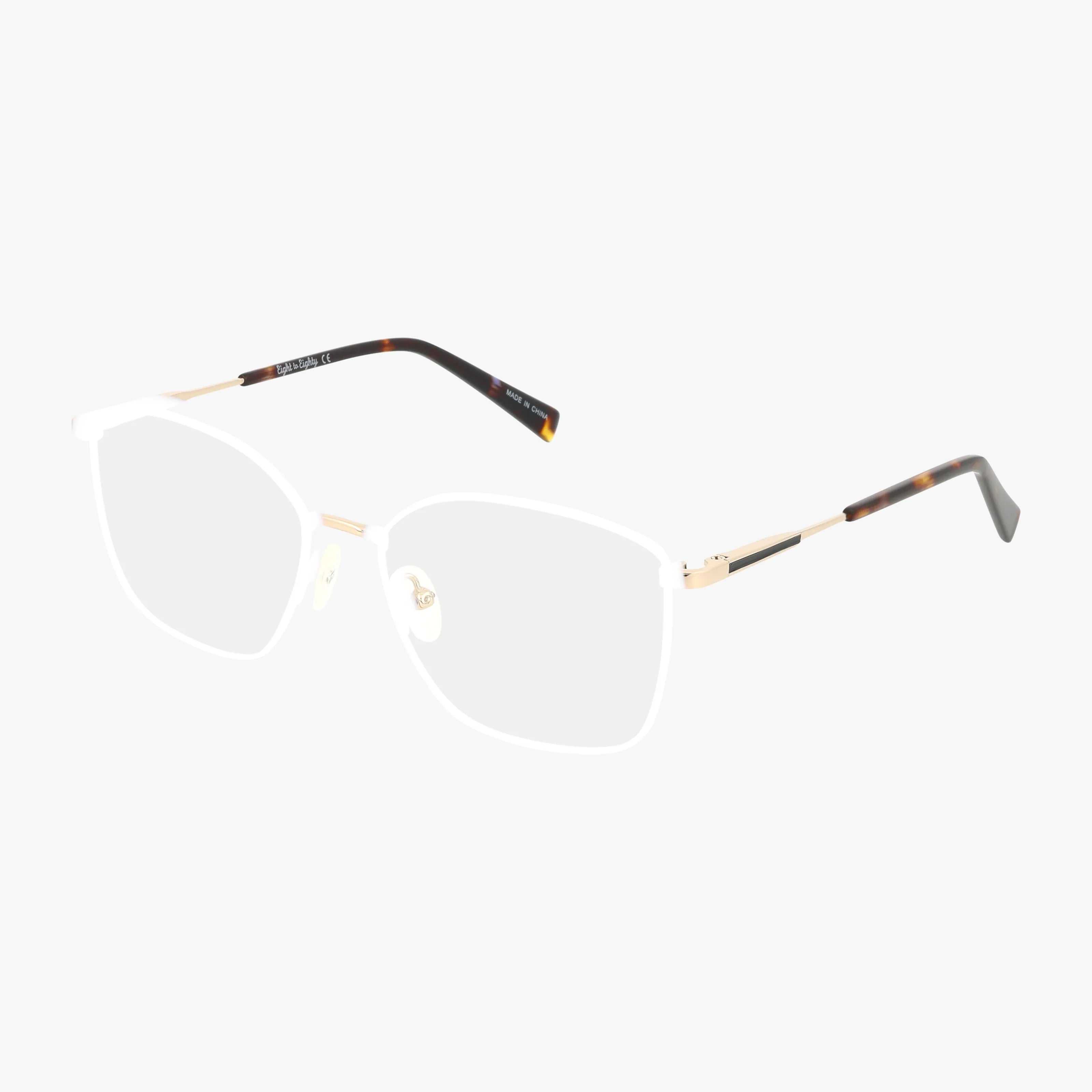 GOLDIE features gold metal rectangular eyeglass frames with clear nose pads and slim arms accented by tortoiseshell-patterned tips, offering a modern twist for a distinctive look, shown against a white background.