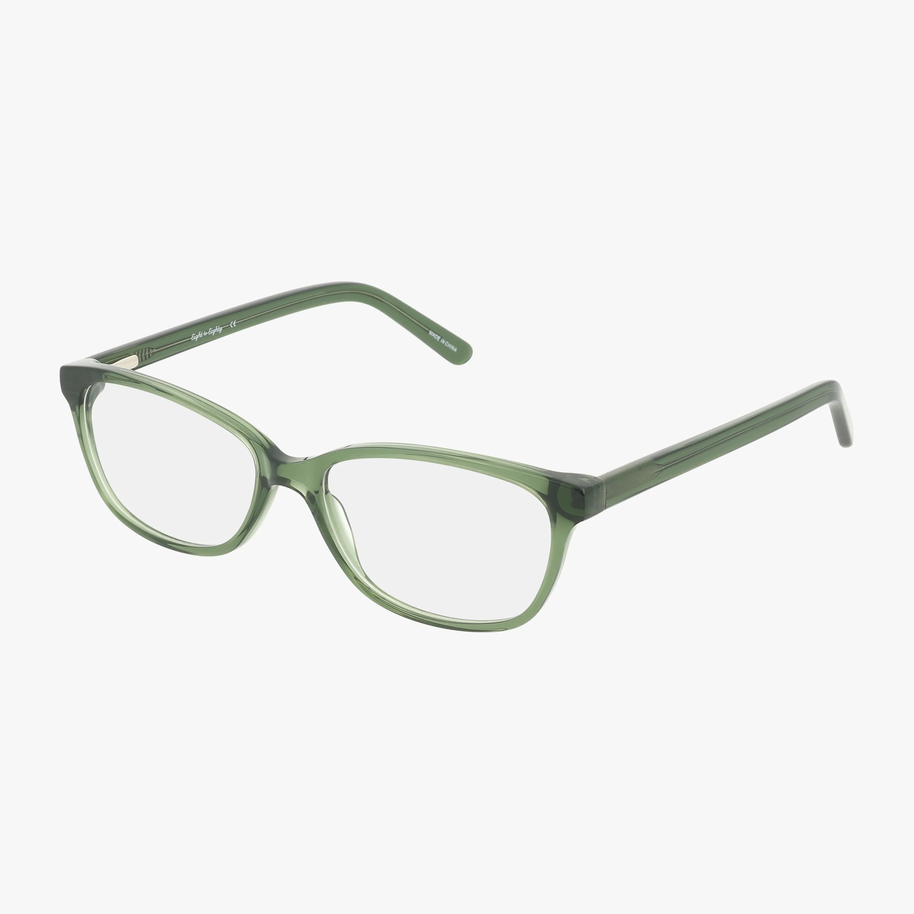 The JOY eyeglasses feature green, translucent oval lenses with prescription options, a distinctive frame, and slightly angled arms, displayed on a white background.