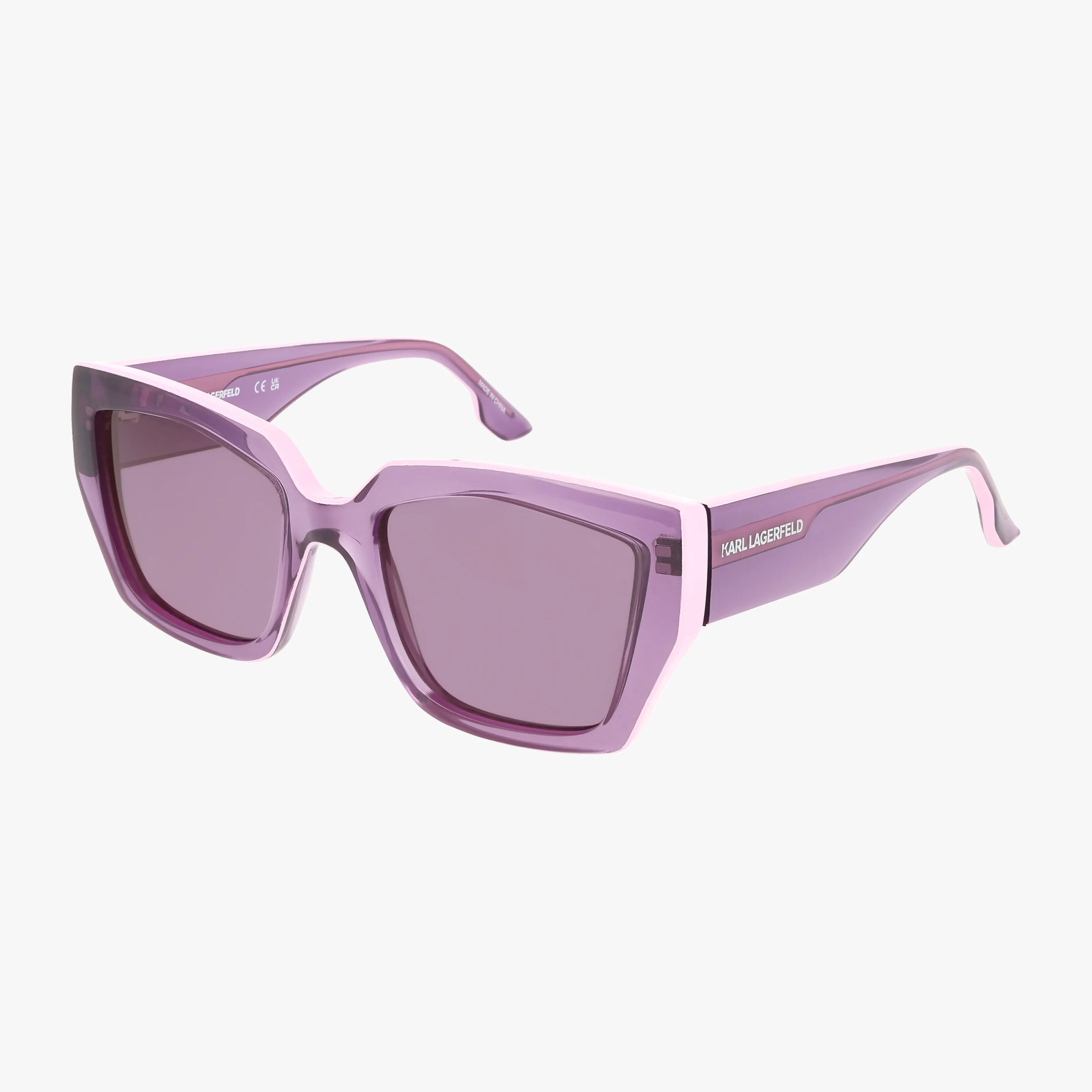The KL6143S are purple oversized square sunglasses with a lightweight, thick translucent frame and tinted lenses. Featuring the KARL LAGERFELD logo in white on the arms, these stylish sunnies elevate your look. Plain white background.