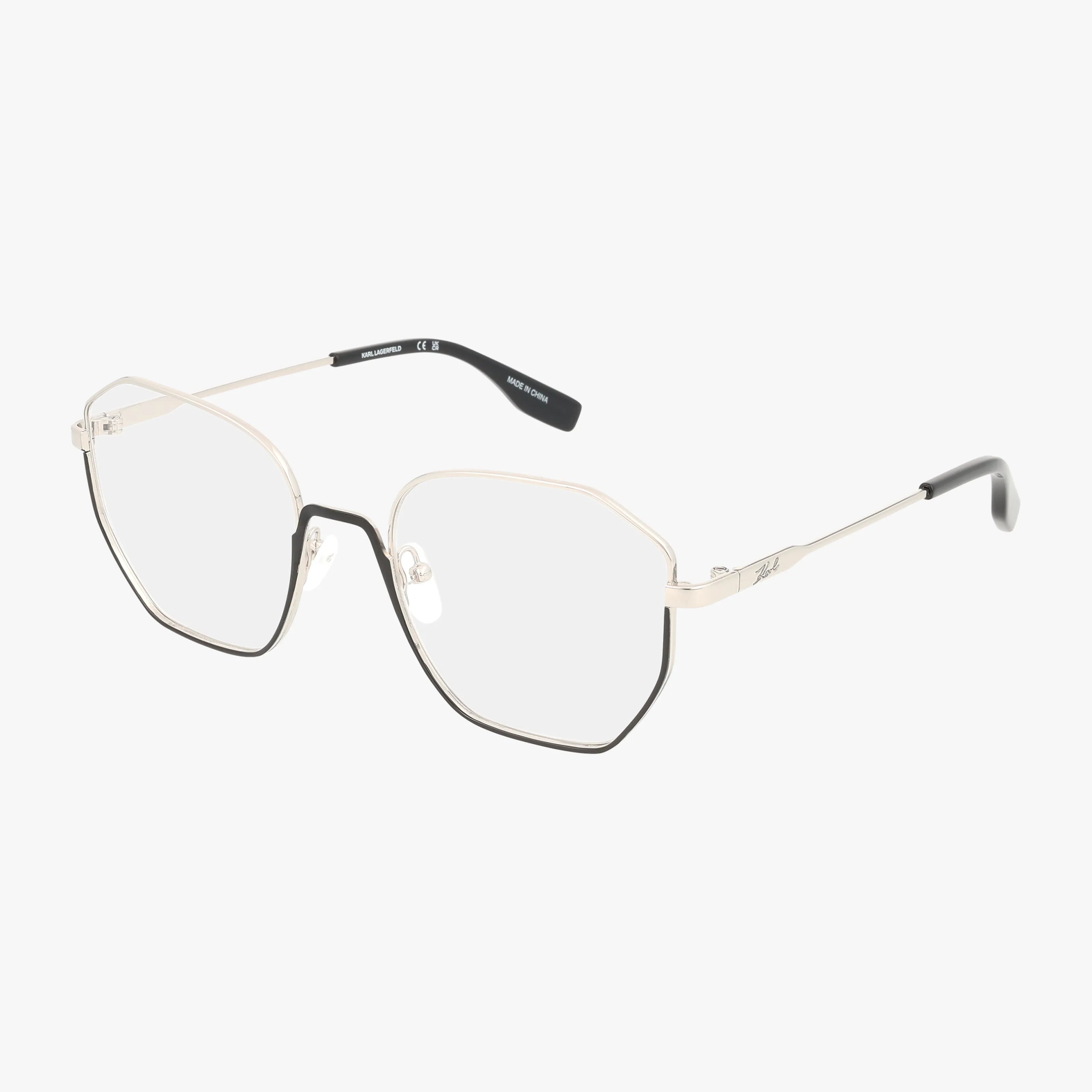 KL356 features geometric hexagonal lenses with thin gold metal frames and black detailing. The bold design is finished with gold temples and black tips, making these eyeglasses a stylish choice for everyday wear.
