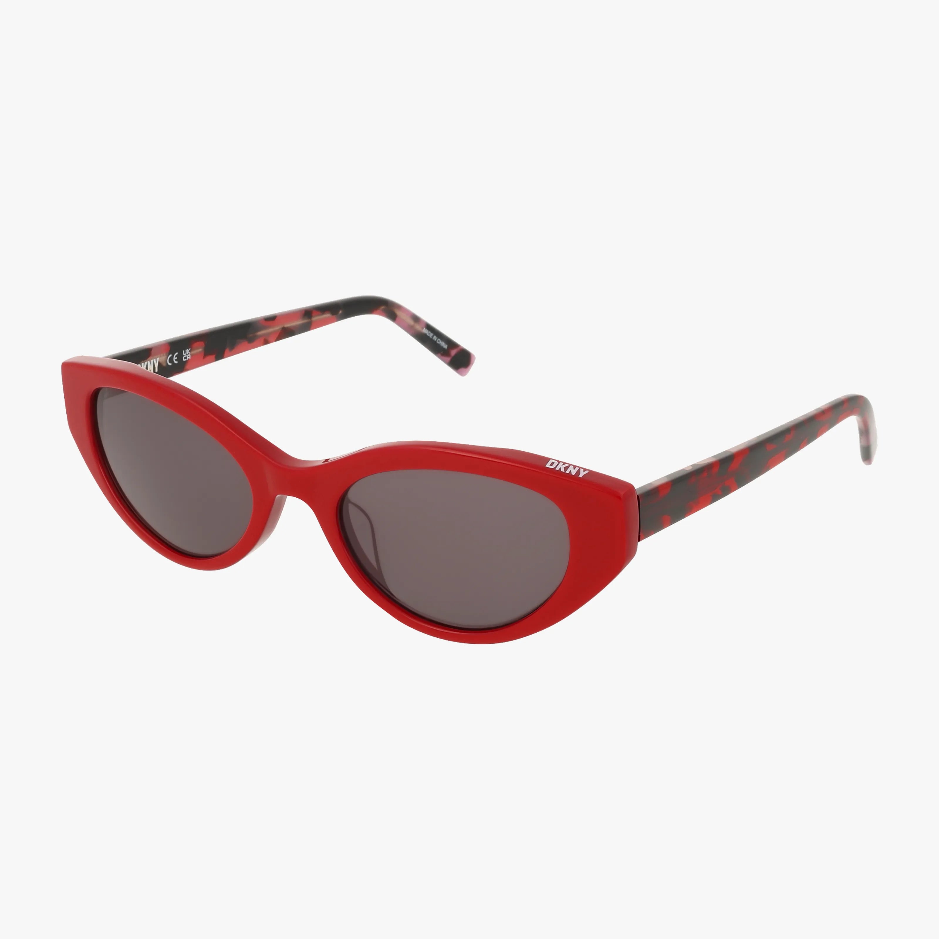 Red cat-eye DKNY sunglasses (model DK548S) with dark lenses and tortoiseshell-patterned acetate arms, displayed against a white background.