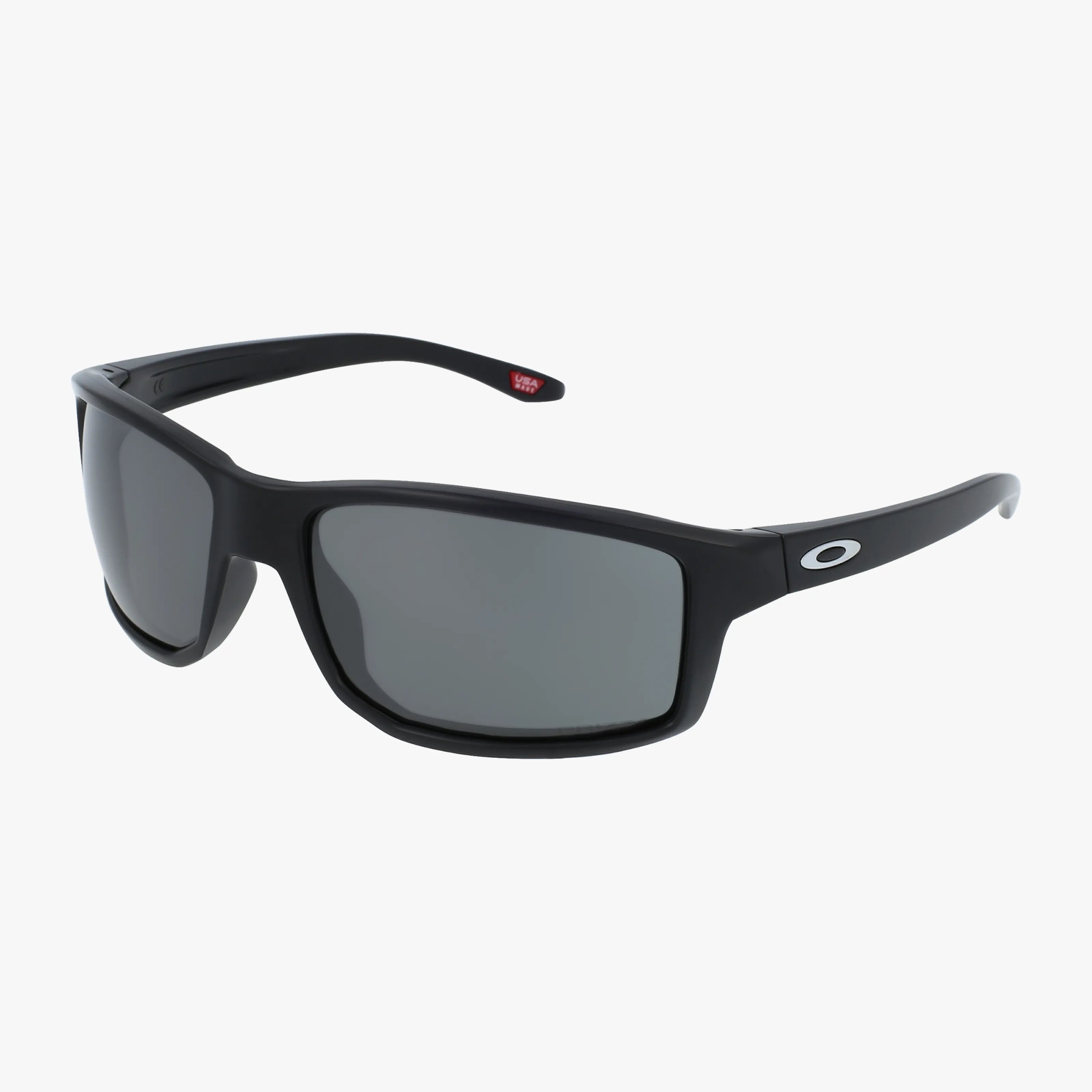 The OO9449 GIBSTON sunglasses feature a black frame, durable rectangular dark-tinted lenses, and a white Oakley O logo on the arms, shown against a plain white background.