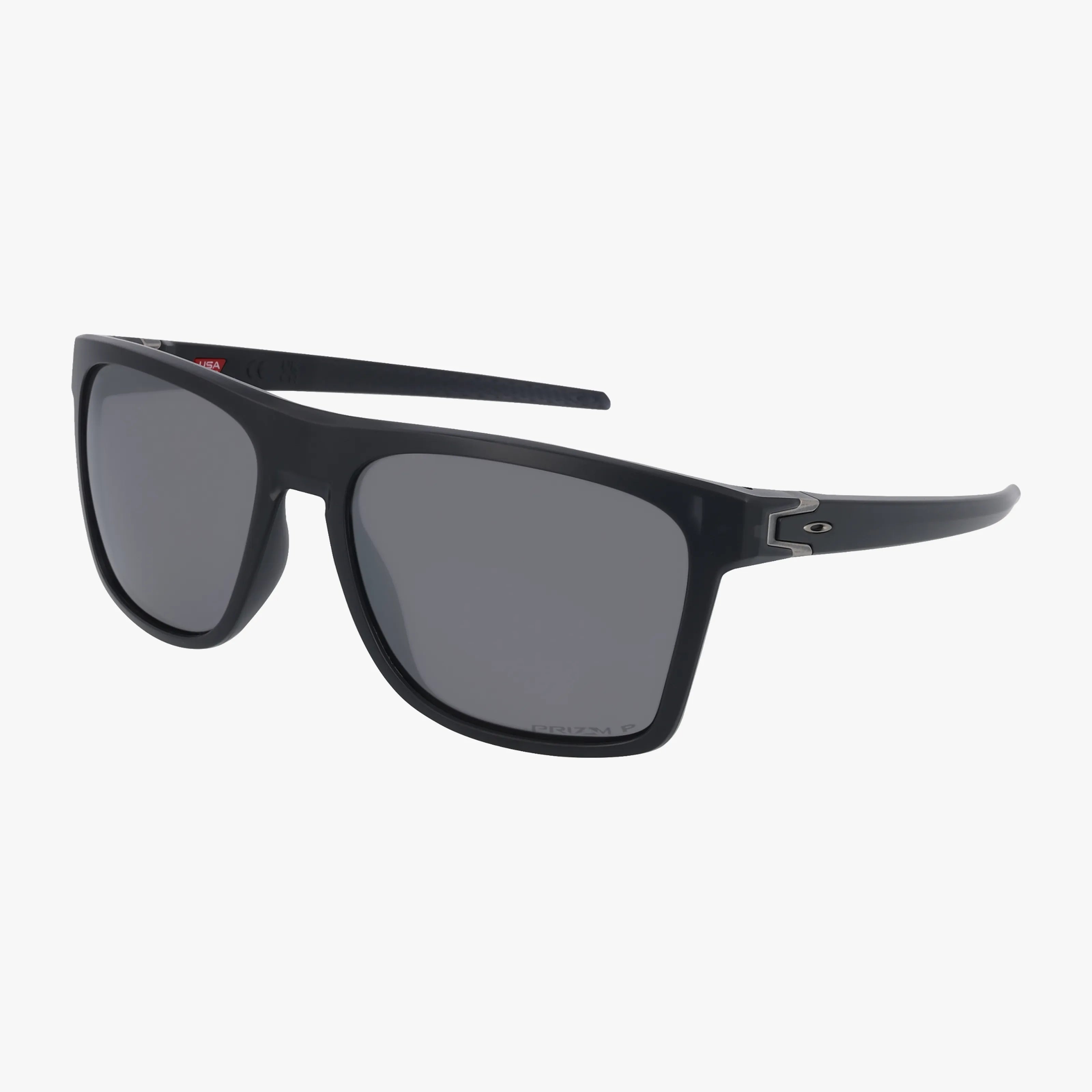 The OO9100 LEFFINGWELL sunglasses feature a lightweight black rectangular frame, dark lenses, and thin arms with subtle metallic accents by the hinges. Set on a plain white background—perfect for online eyewear shoppers.