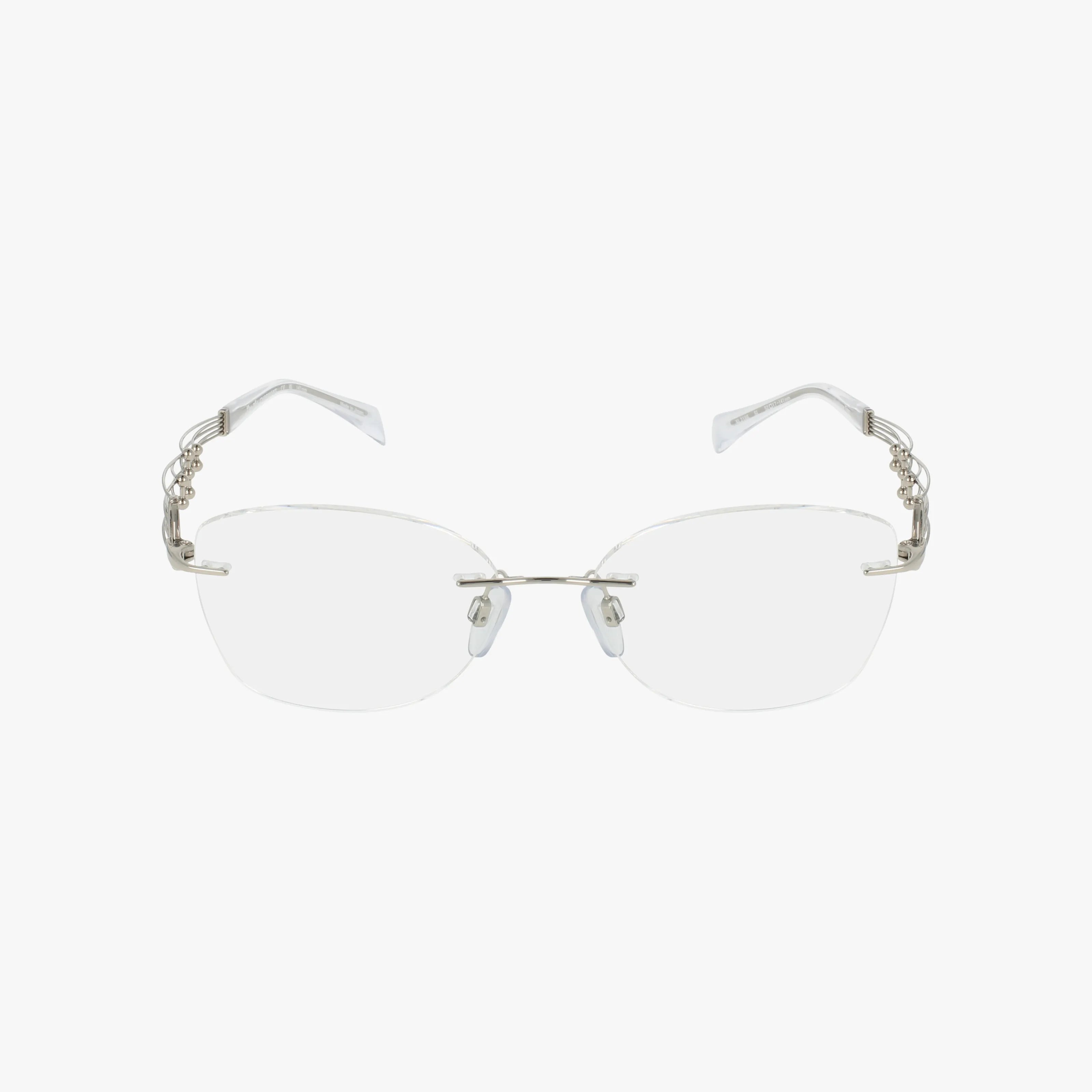 The 2186 eyeglasses feature a rimless design with clear lenses, silver metal temples, and intricate decorative arm details. Combining modern style with a durable frame, they're showcased on a plain white background.