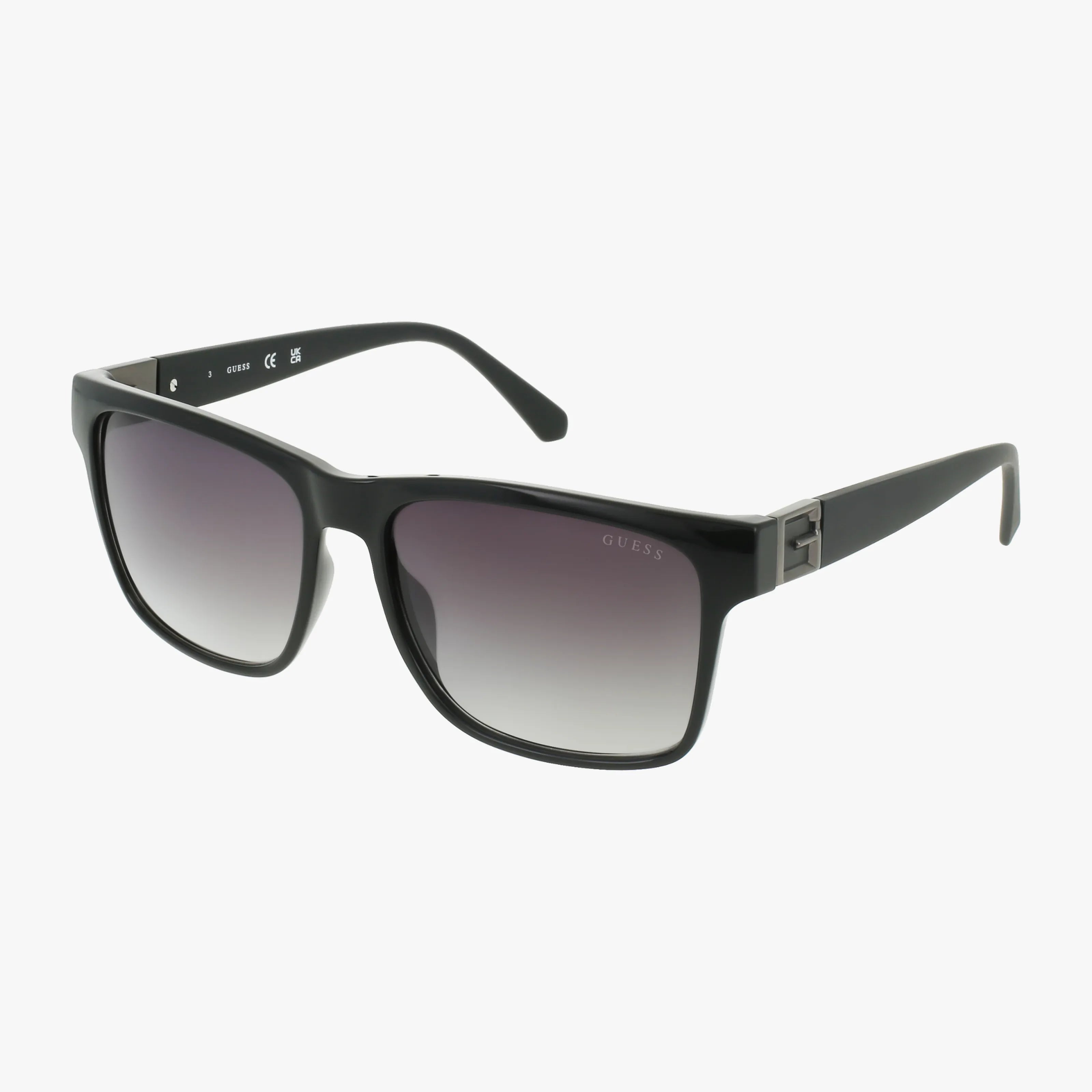 The GU00004S sunglasses feature a black rectangular frame with dark gradient lenses, thick plastic construction, and a subtle metallic accent on the arms. Sleek and versatile, theyre perfect for any look. Shown on a plain white background.