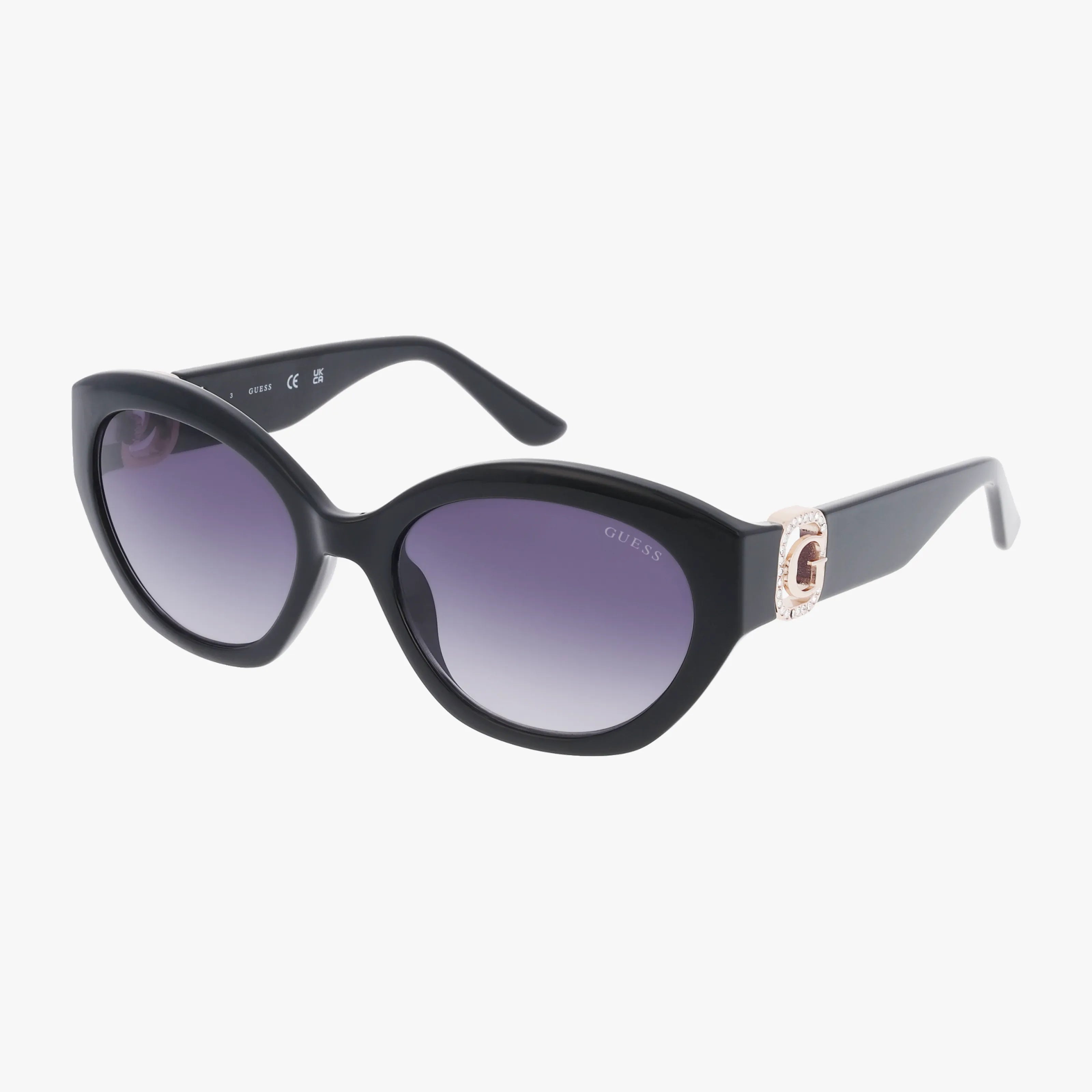 The GU00104/S black cat-eye sunglasses feature dark gradient lenses and a gold-toned “G” logo on the temples. Glossy, thick frames deliver chic sun protection and elevate any look, shown here against a white background.