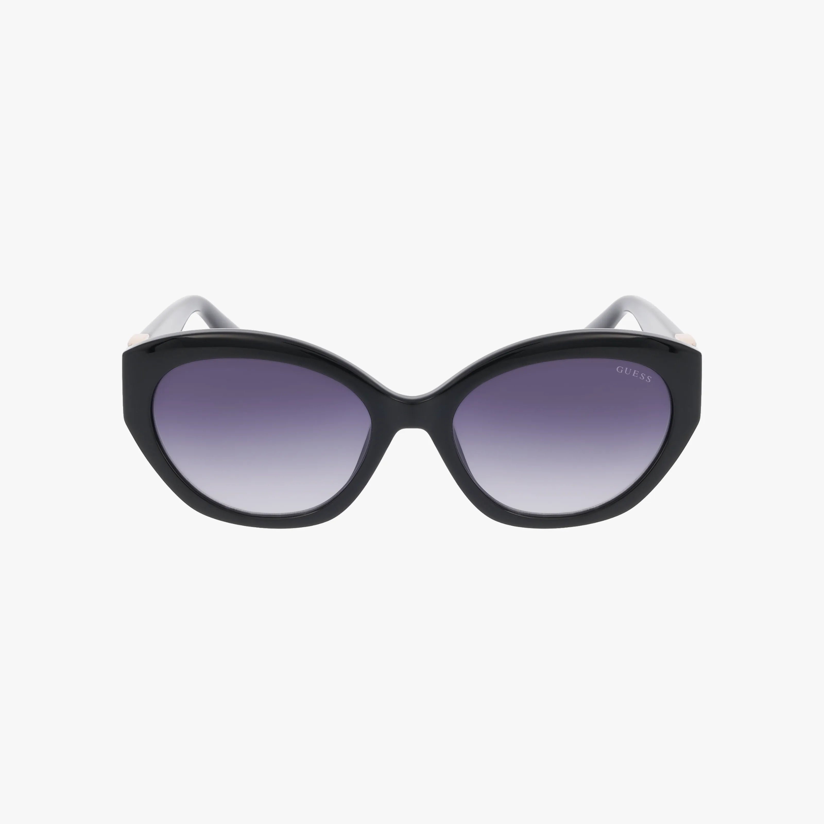 The GU00104/S sunglasses are black, oversized cat-eye frames with dark gradient lenses, providing chic sun protection and shown on a plain white background.