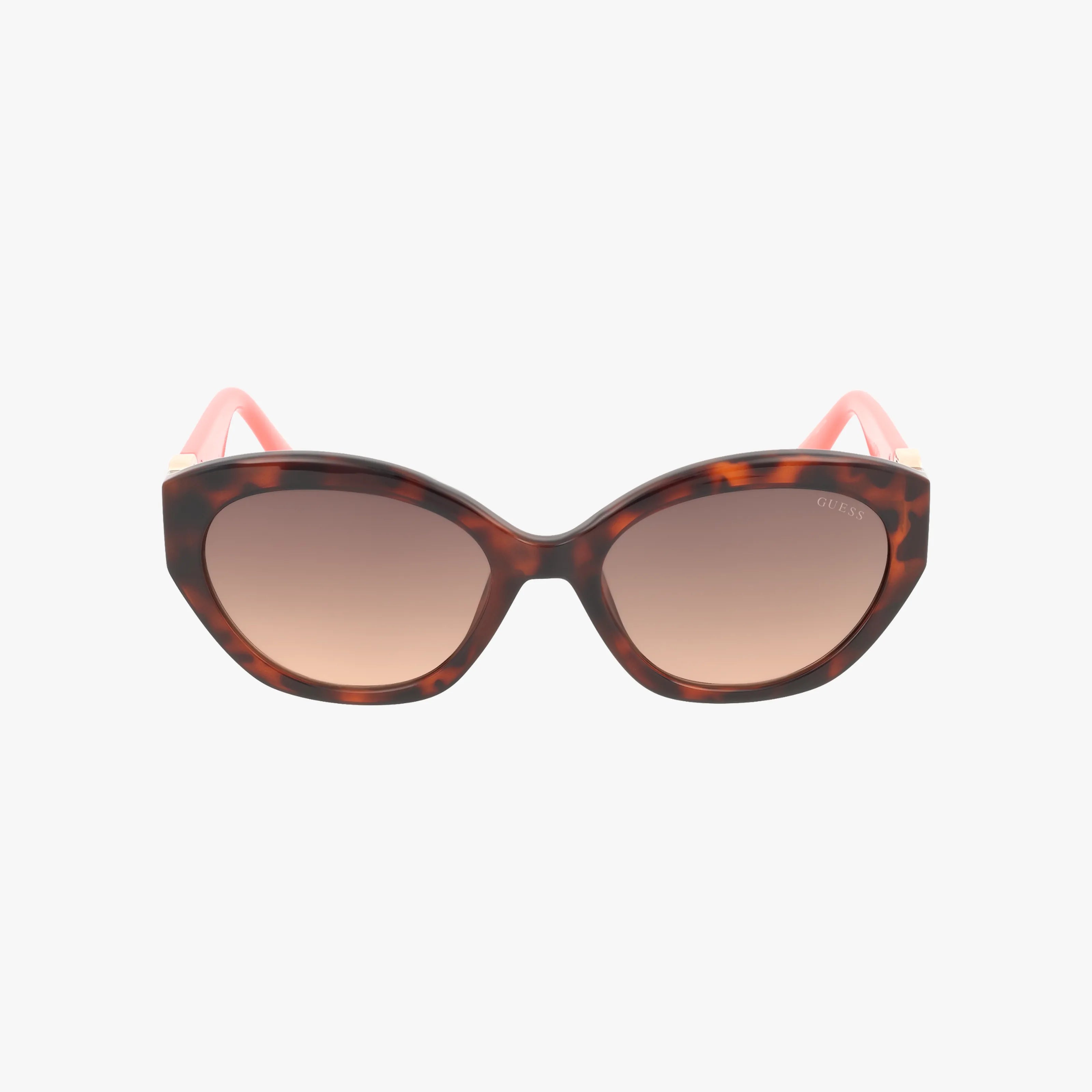 The GU00104/S sunglasses showcase large rounded tortoiseshell frames, brown gradient lenses, and pink arms with gold accents near the hinges—blending chic style and sun protection in one fashionable accessory.