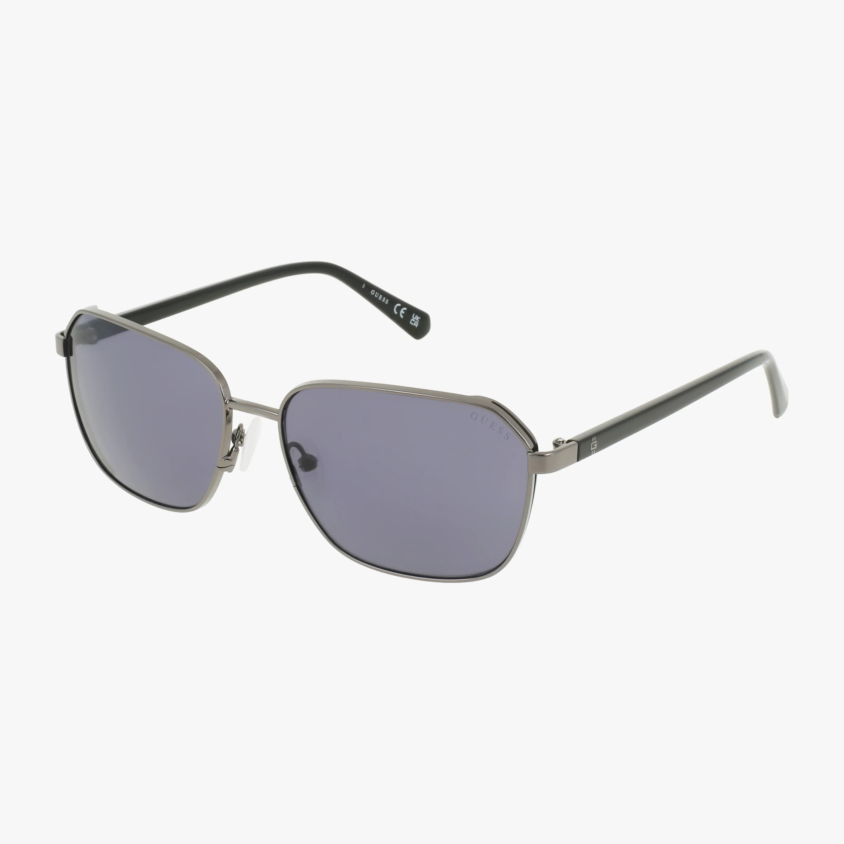 The GU00117 sunglasses feature a durable metallic frame, rectangular slightly curved dark lenses, and black temples with silver accents.