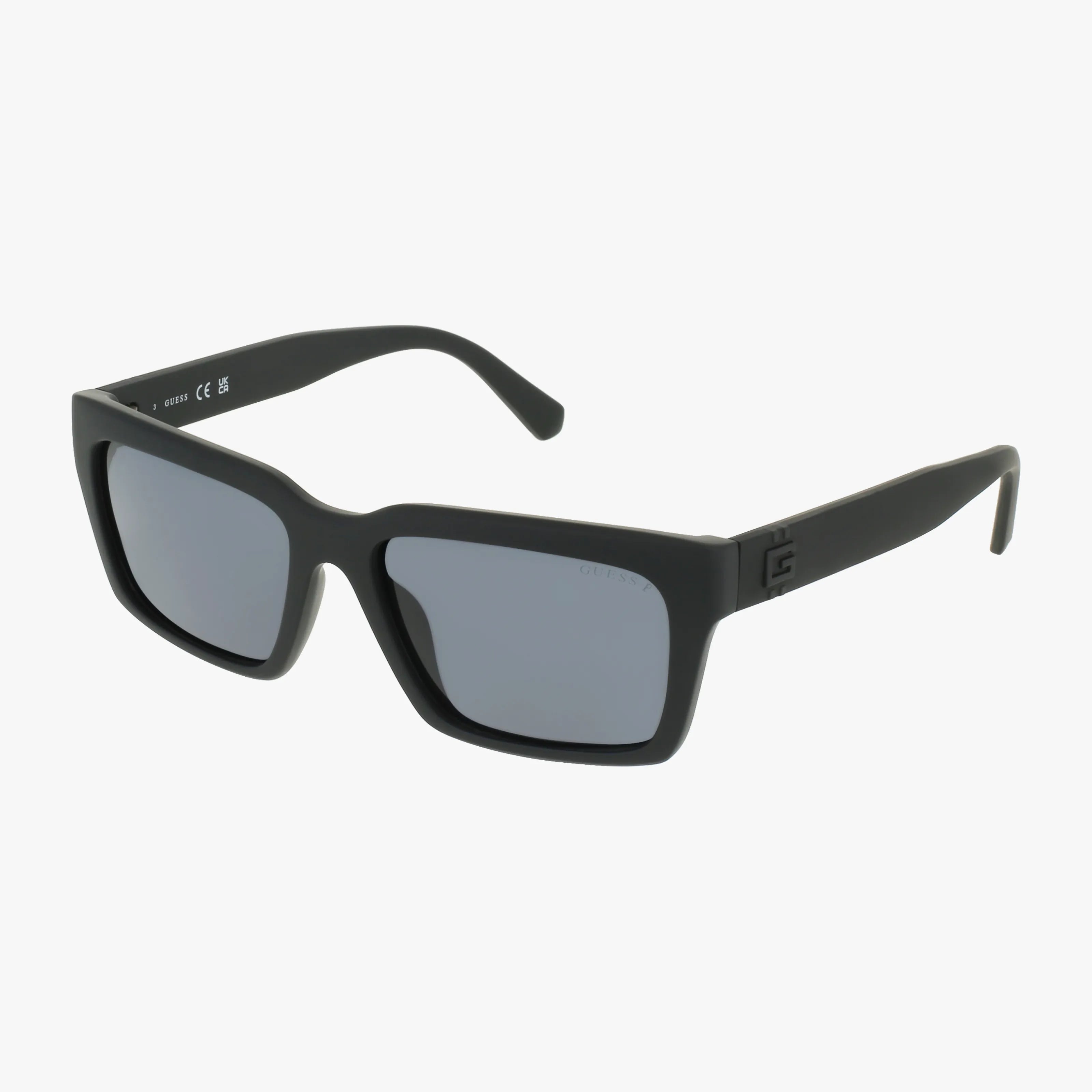 GU00121/S black rectangular sunglasses feature thick, matte, lightweight frames and dark lenses. Shown angled on a plain white background, they’re perfect for everyday wear.