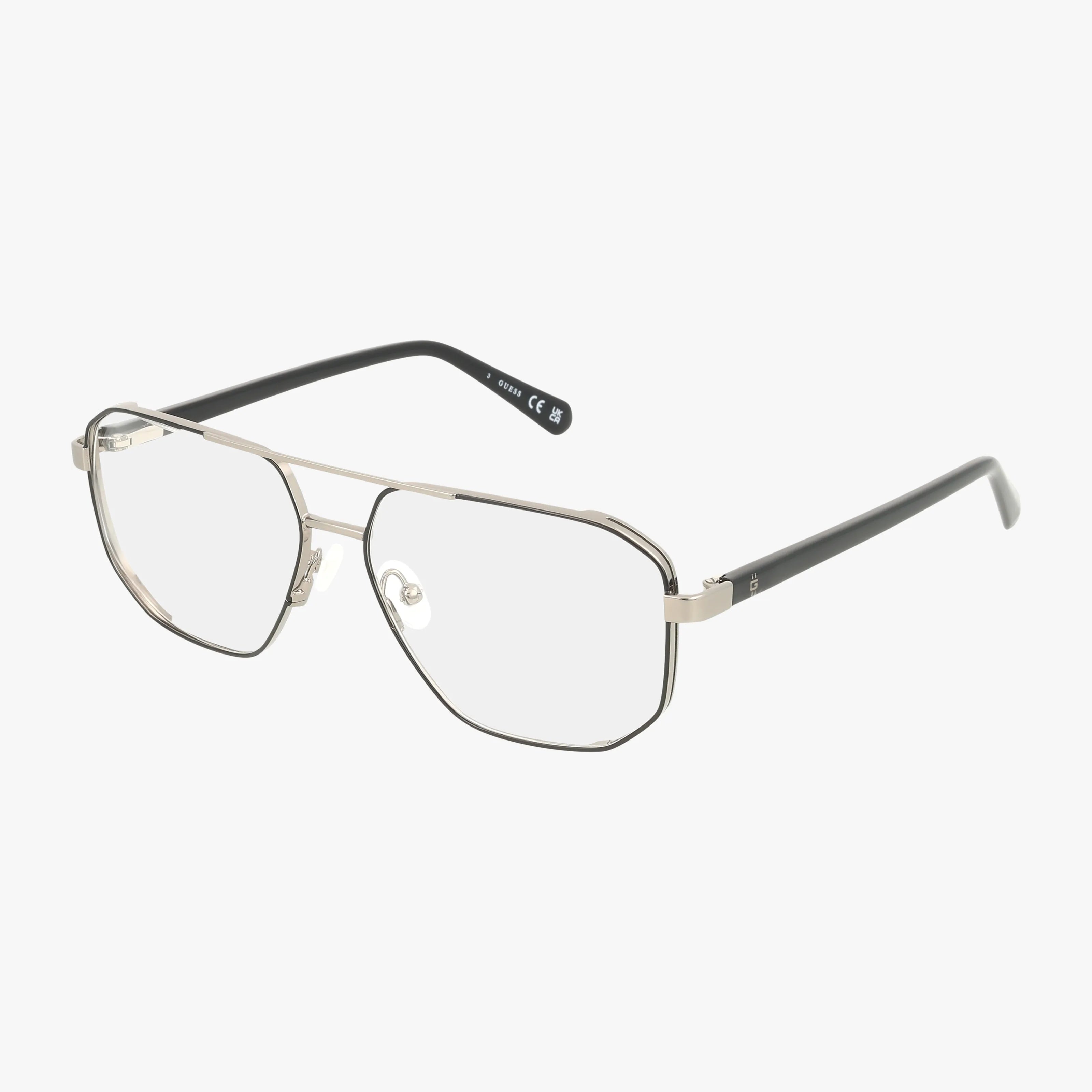 The GU50135/V eyeglasses have a chic frame with thin silver metal and large geometric lenses. The black temples curve slightly at the ends, combining style and vision benefits. Displayed on a white background.