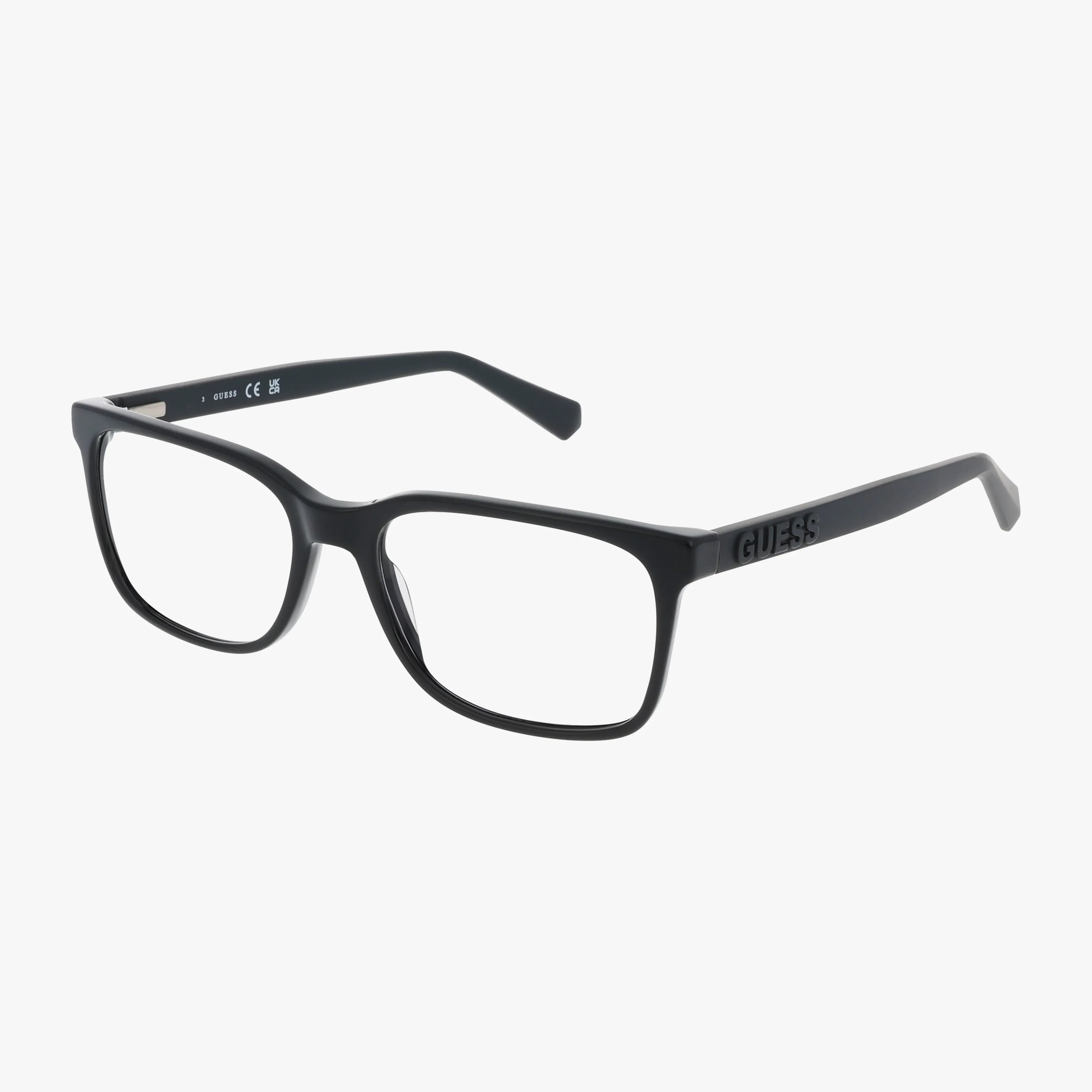 The GUESS 50187 is a pair of black rectangular eyeglasses with thick frames, clear prescription lenses, and the brand name on the left arm, shown on a white background.