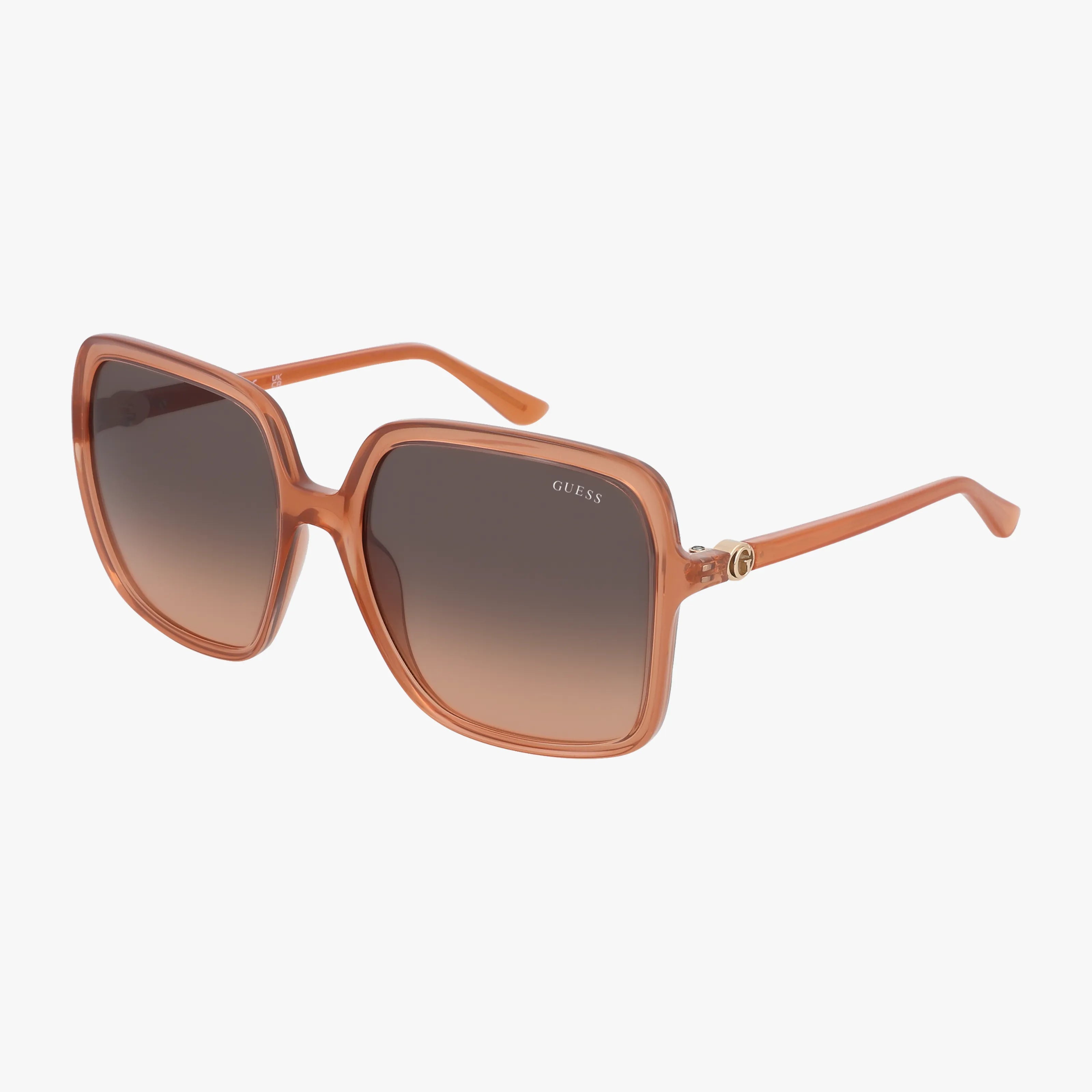 The GUESS GU00280 sunglasses feature a square shape with a light brown translucent frame, gradient brown lenses, gold accents near the hinges, and the GUESS logo on one lens.