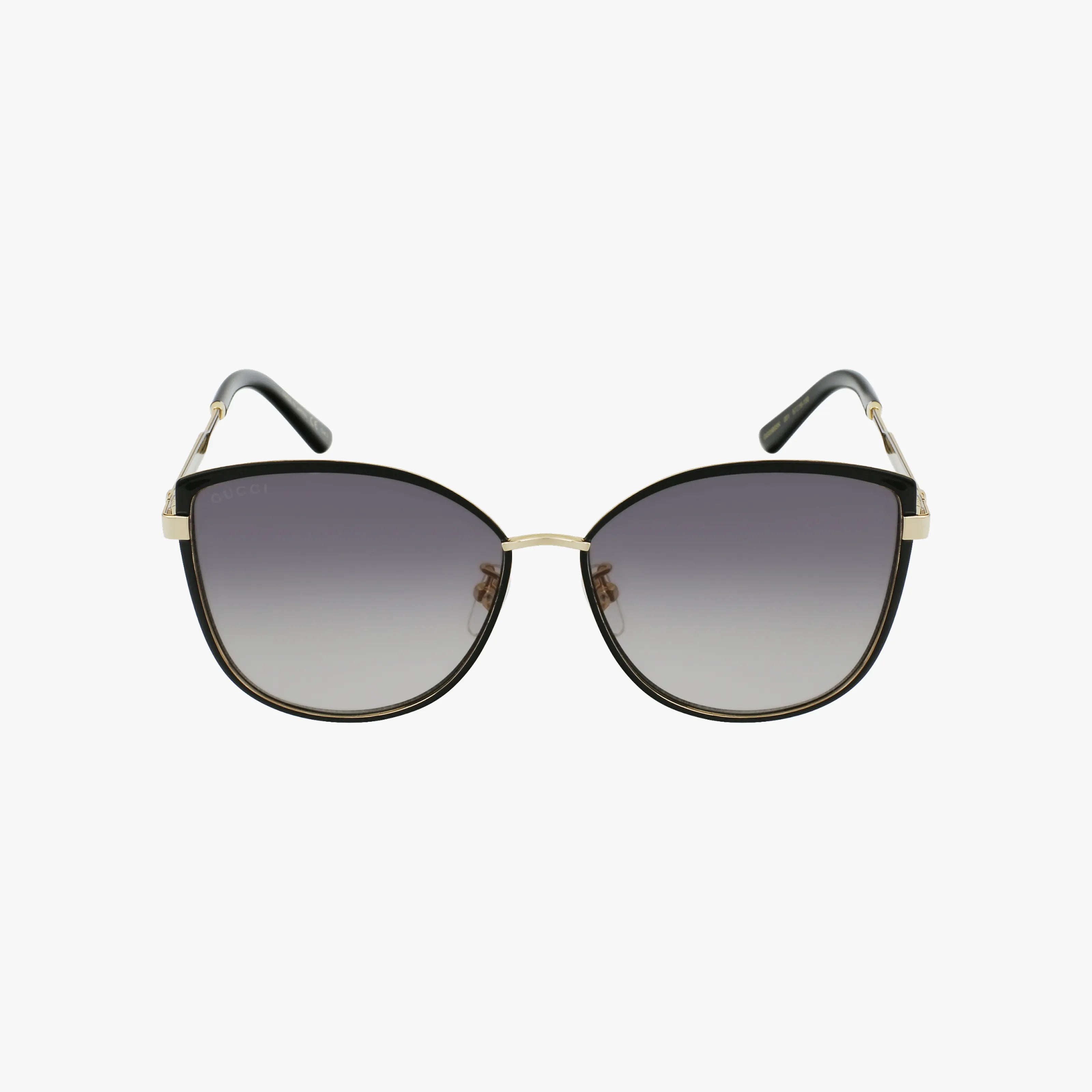 The GG0589SK sunglasses feature large, rounded black frames, gold temple accents, and dark gradient lenses, all presented against a plain white background.
