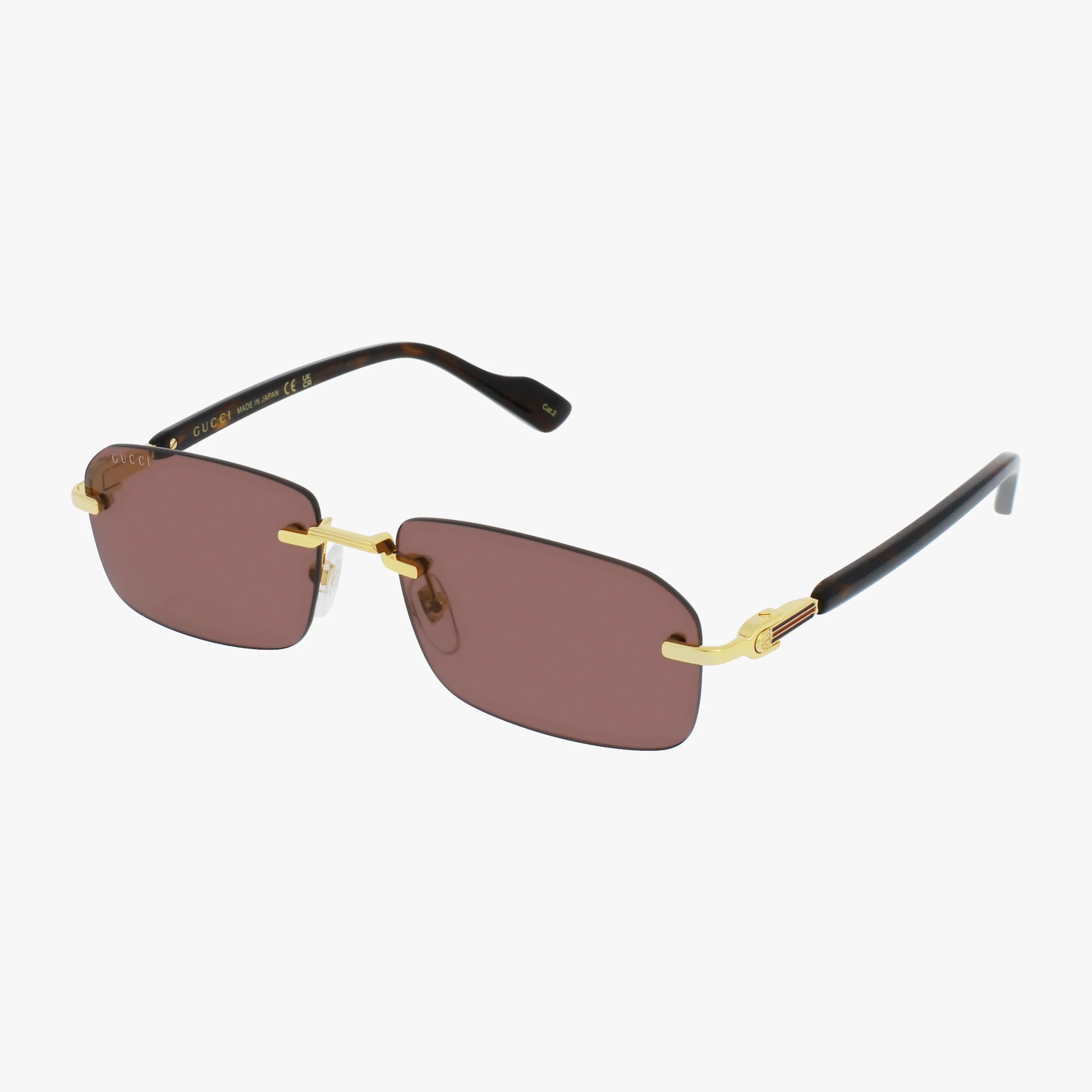 The GG1221S rimless sunglasses feature rectangular brown lenses, a gold-tone bridge and temples, black curved earpieces, and offer UV protection—combining eye safety with style. Shown against a white background.