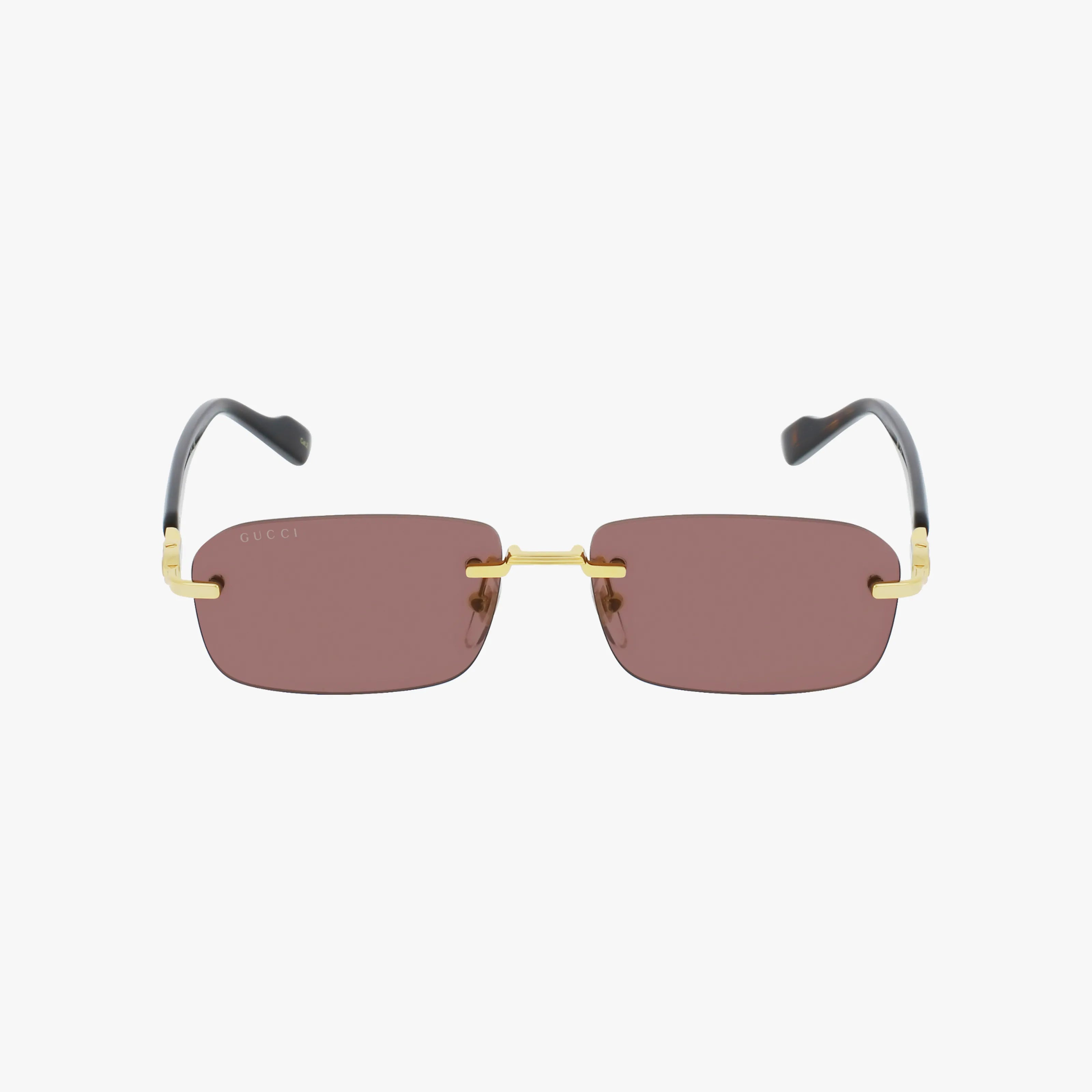 The Gucci GG1221S sunglasses feature rimless rectangular brown-tinted UV-protective lenses, a gold metal bridge and arms, black curved temple tips, and a subtle Gucci logo on the top left lens.