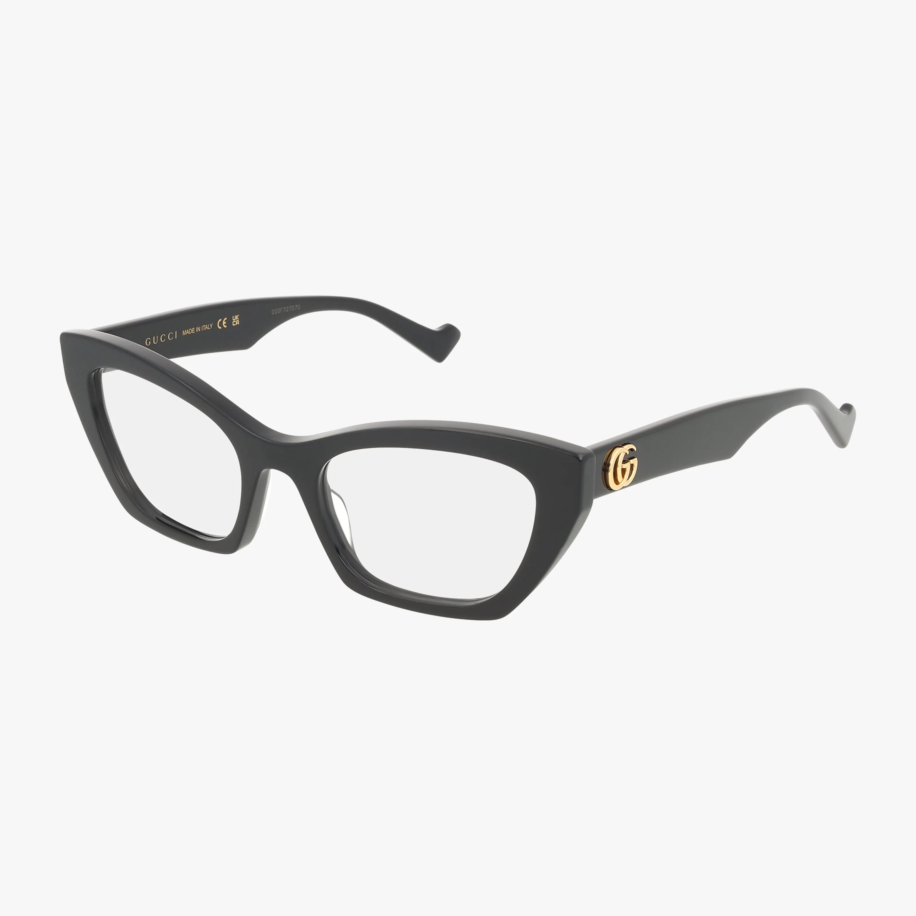 The GG1334O eyeglasses feature a black cat-eye frame, bold design, gold GG Gucci logo on the temples, and clear prescription lenses, shown against a white background.