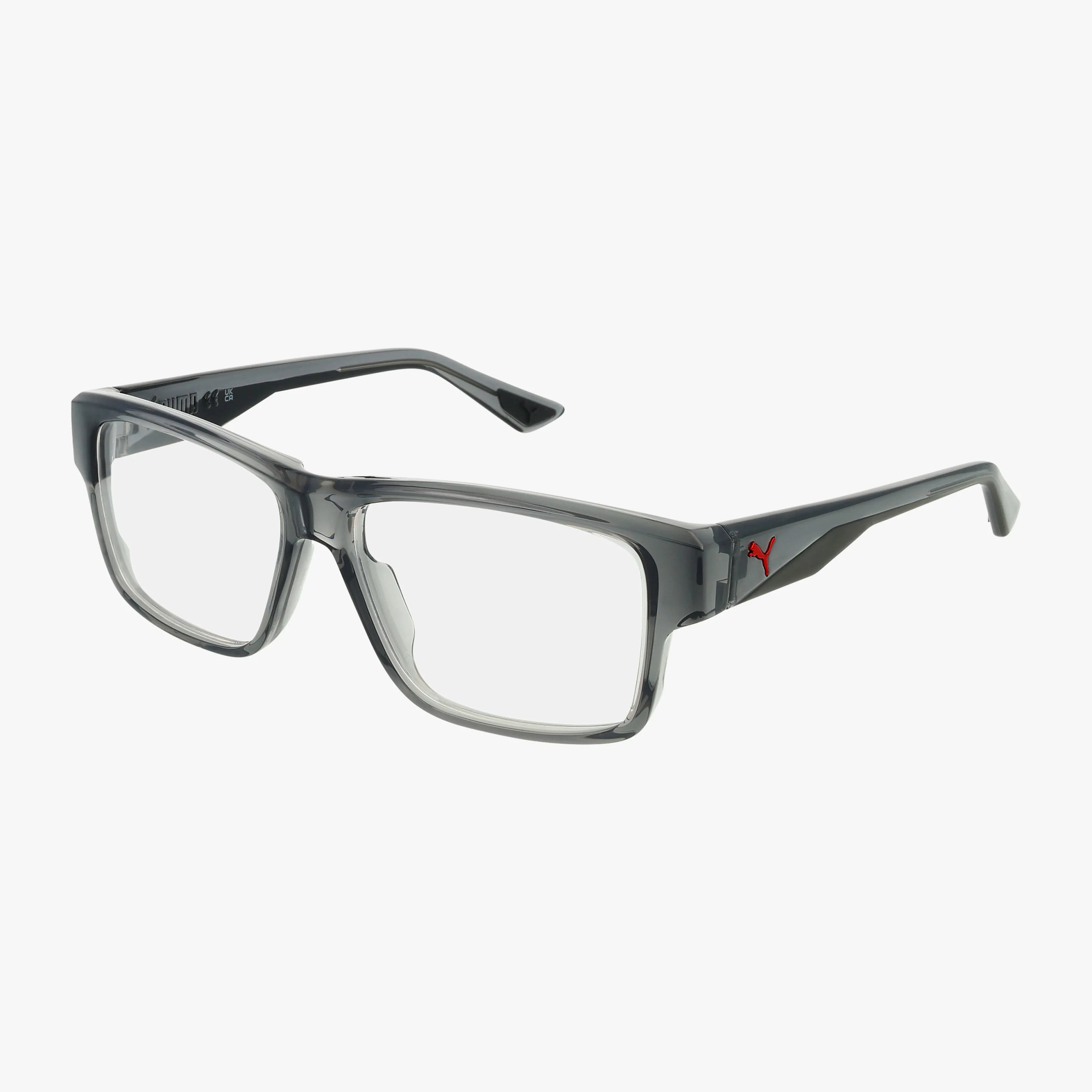The PU0408O eyeglasses feature rectangular, transparent gray frames with thick, modern styling. Black arms display a small red Puma logo. These durable frames include clear prescription lenses, shown against a white background.