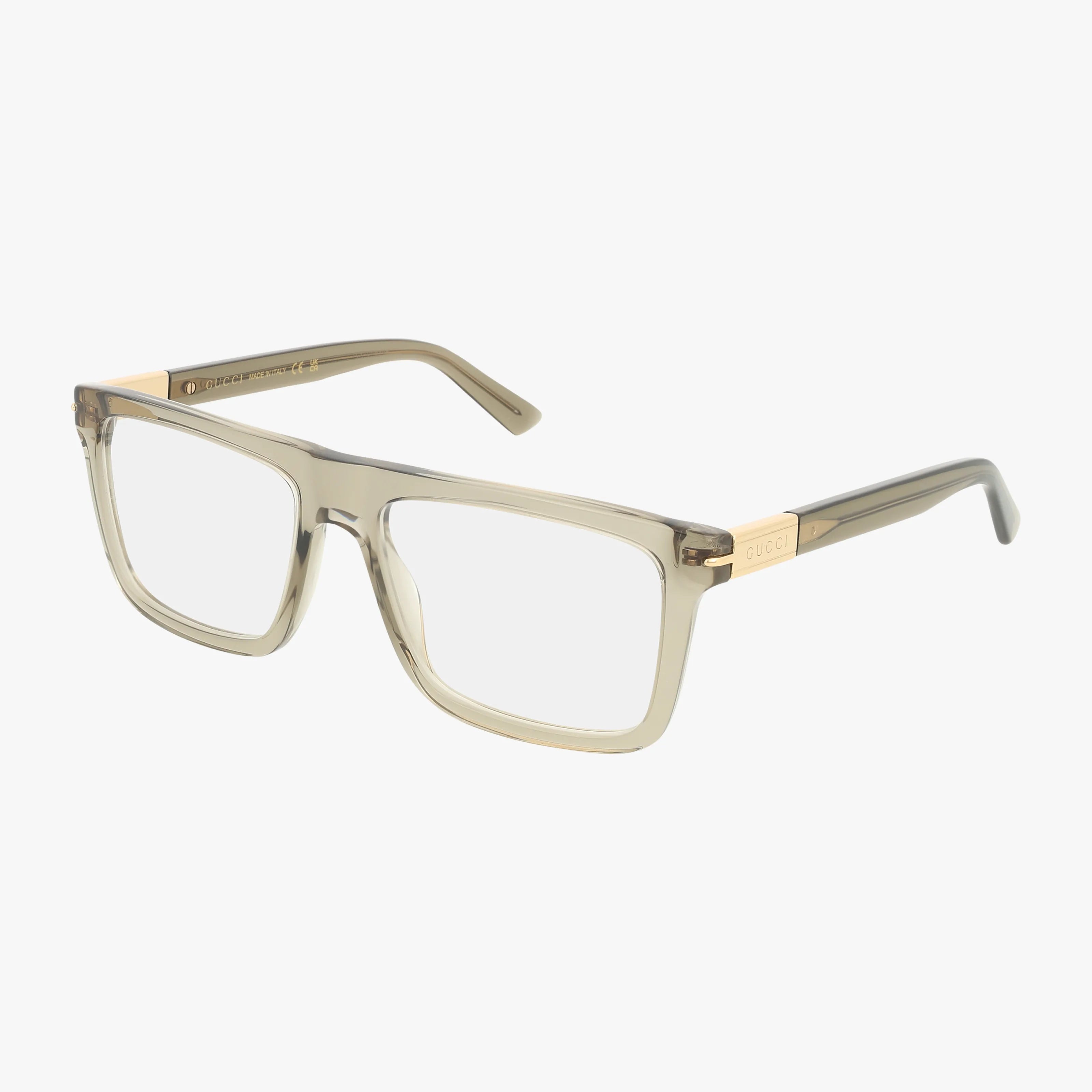 The GG1504O rectangular eyeglasses feature a transparent light beige polished frame with gold-accented temples and signature GUCCI branding on the sides, combining style and durability. Shown on a white background.