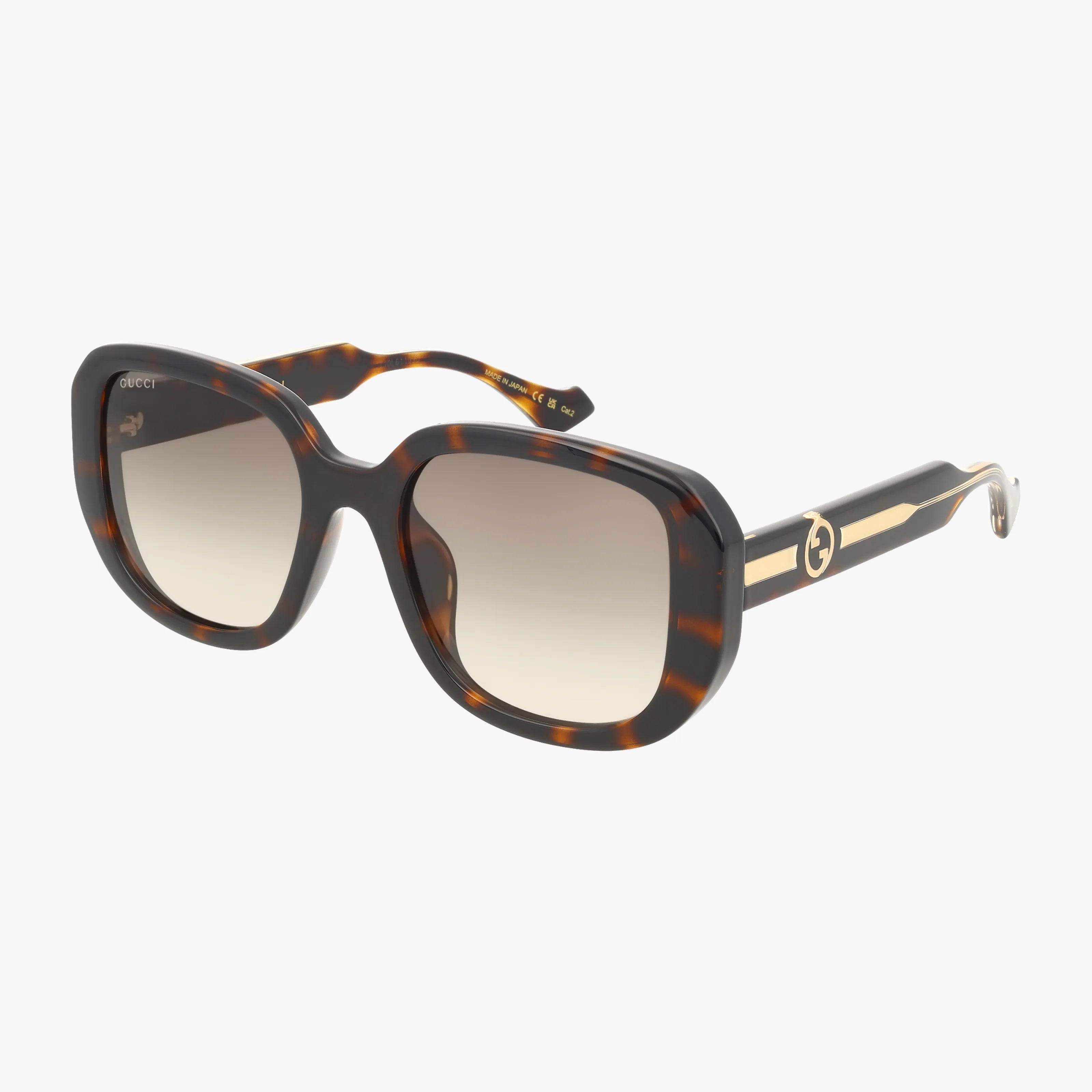 The GG1557SK sunglasses feature a classic tortoiseshell square frame, large gradient lenses, thick arms with a gold stripe, and a circular gold Gucci logo on the side—an eye-catching designer accessory.