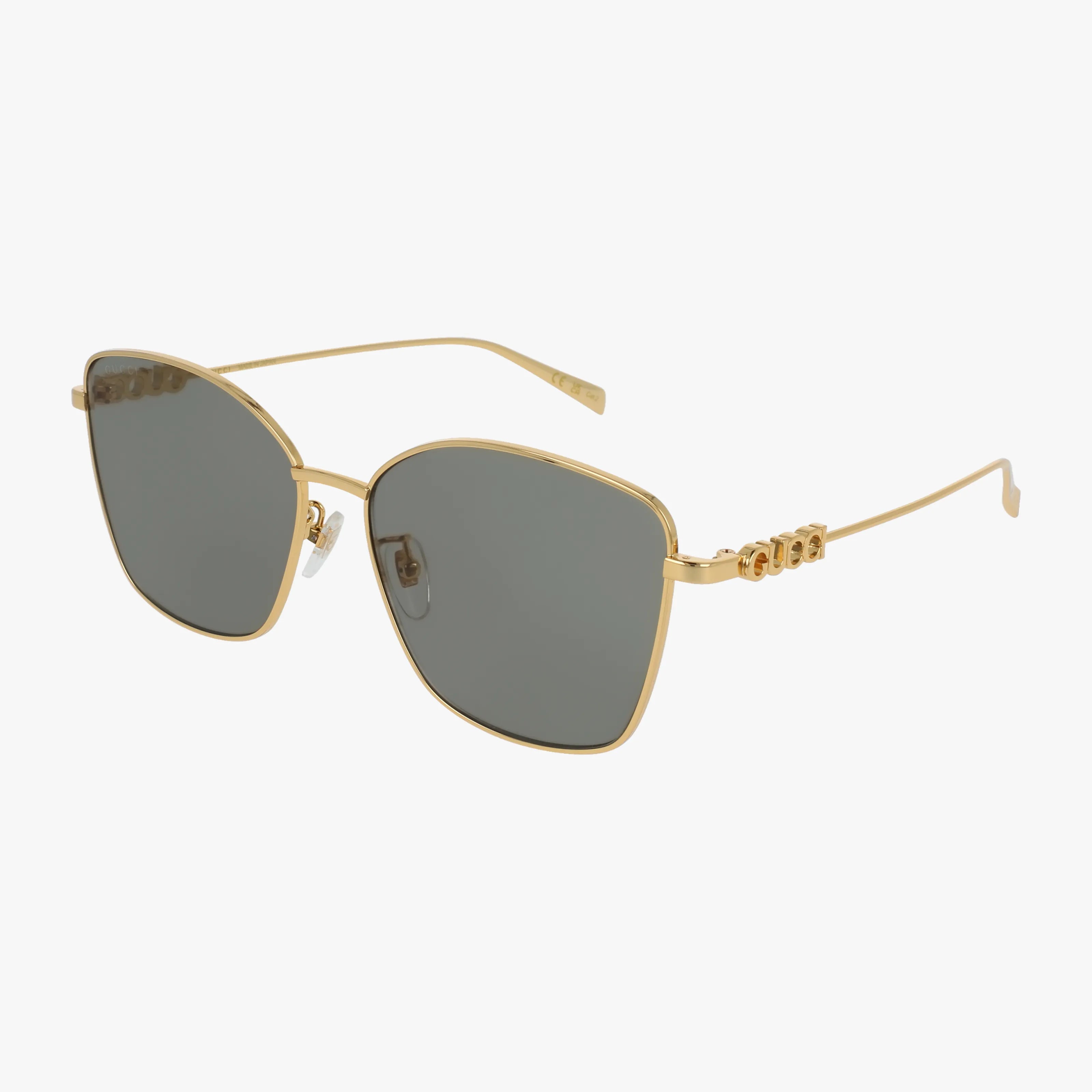 The GG1805SA sunglasses feature gold square frames, dark tinted lenses, and thin arms. A decorative logo accents the temples for chic sun protection. Stylishly displayed against a white background.