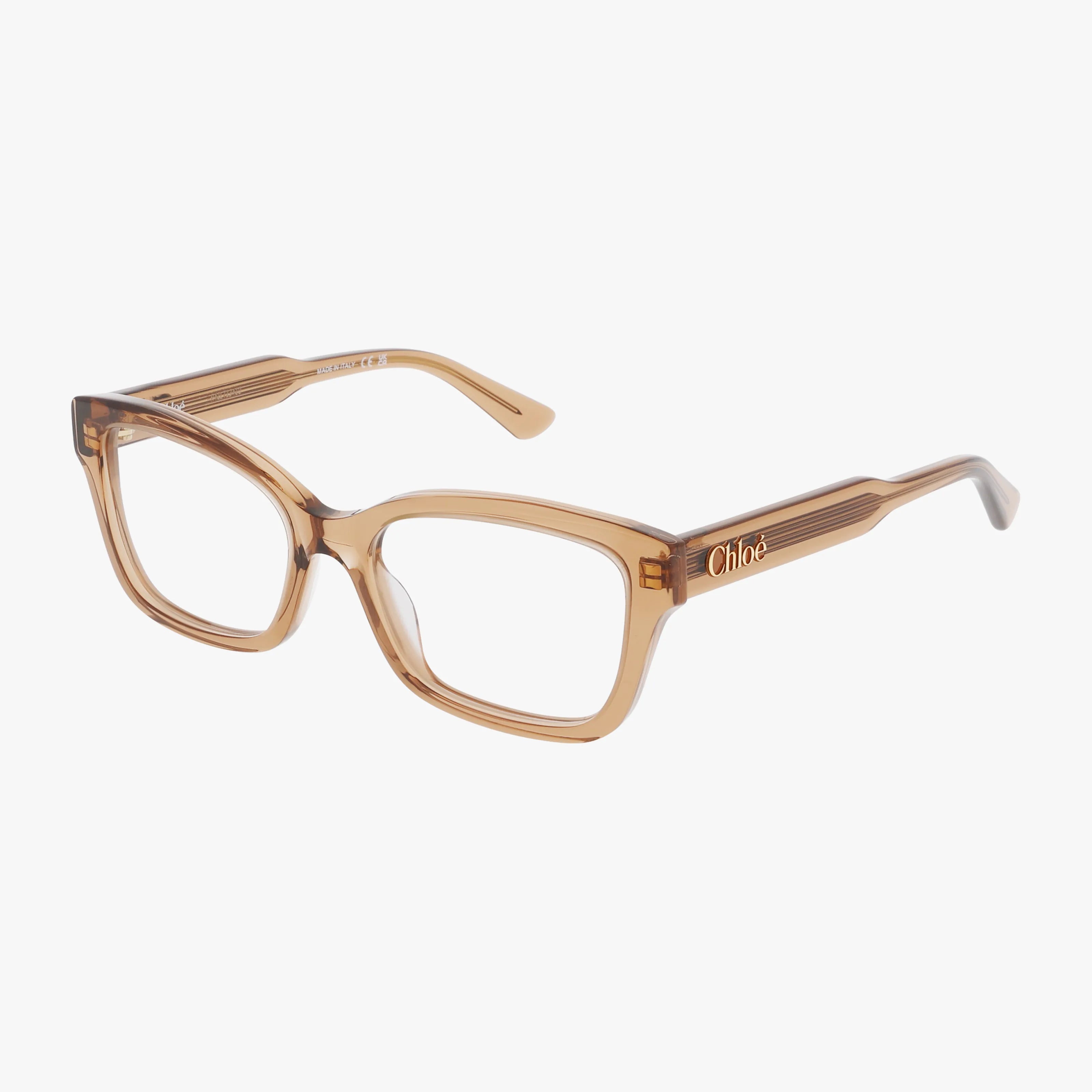 The CH0380O eyeglass frames feature a transparent brown rectangular design with subtle ridged arms and the “Chloé” brand name in gold on the temples, shown against a white background.